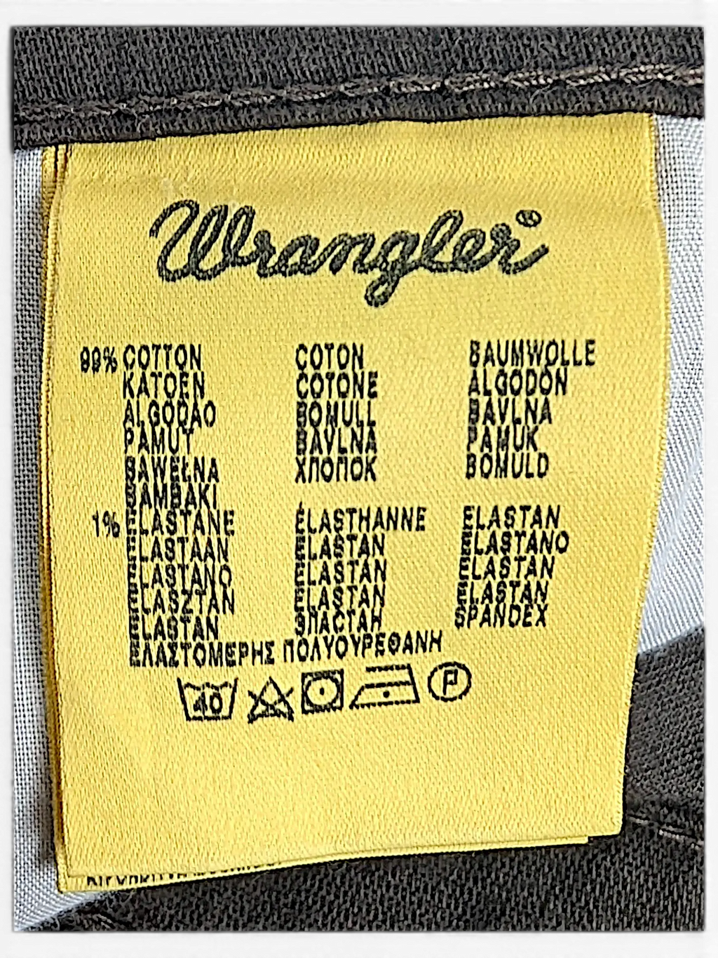 JAKE & IPI Wrangler Texas stretch pants yellow fabric care label showing 99 percent cotton and 1 percent elastane