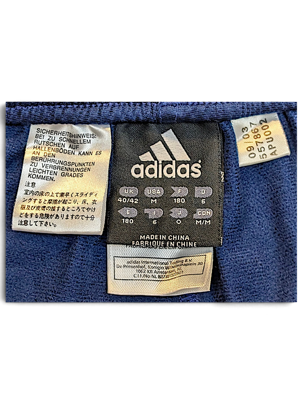 JAKE & IPI adidas track pants size M clothing label with manufacturing and care information