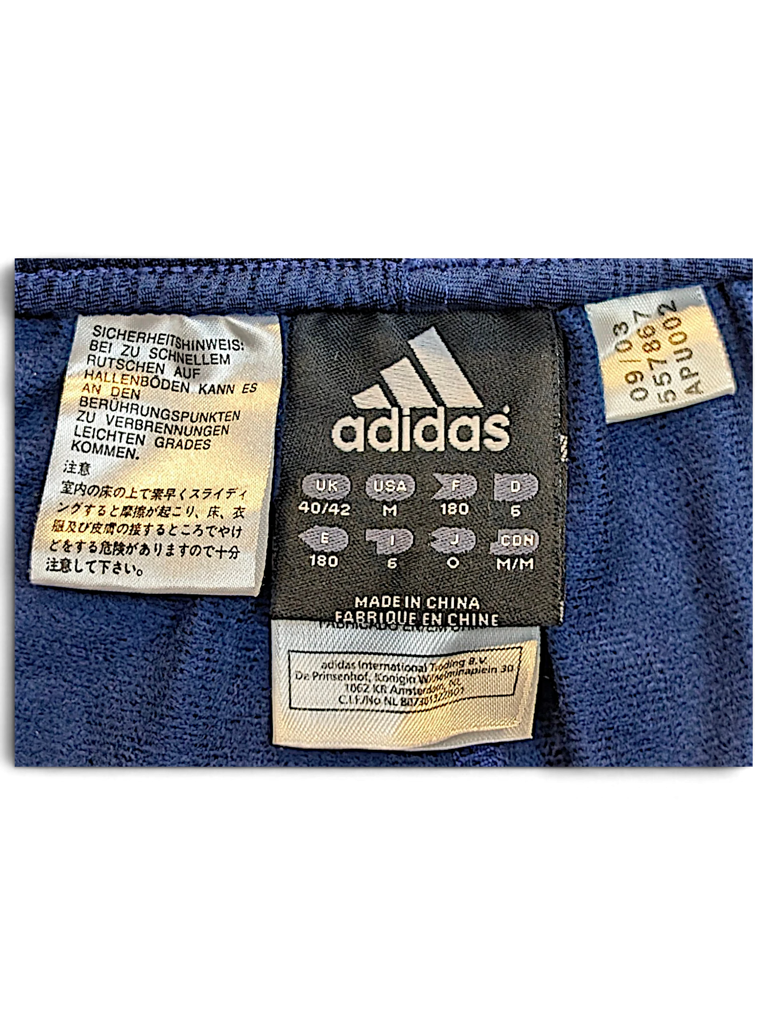 JAKE & IPI adidas track pants size M clothing label with manufacturing and care information