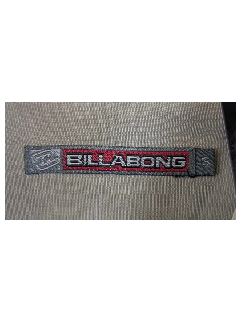 JAKE & IPI Billabong Hawaiian shirt in beige with a size small label on a hanger