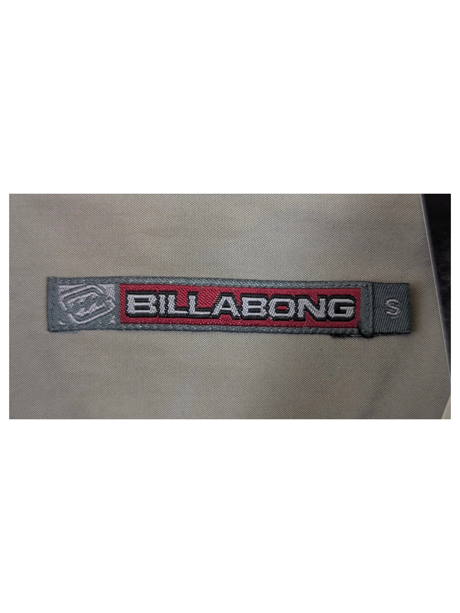 JAKE & IPI Billabong Hawaiian shirt in beige with a size small label on a hanger