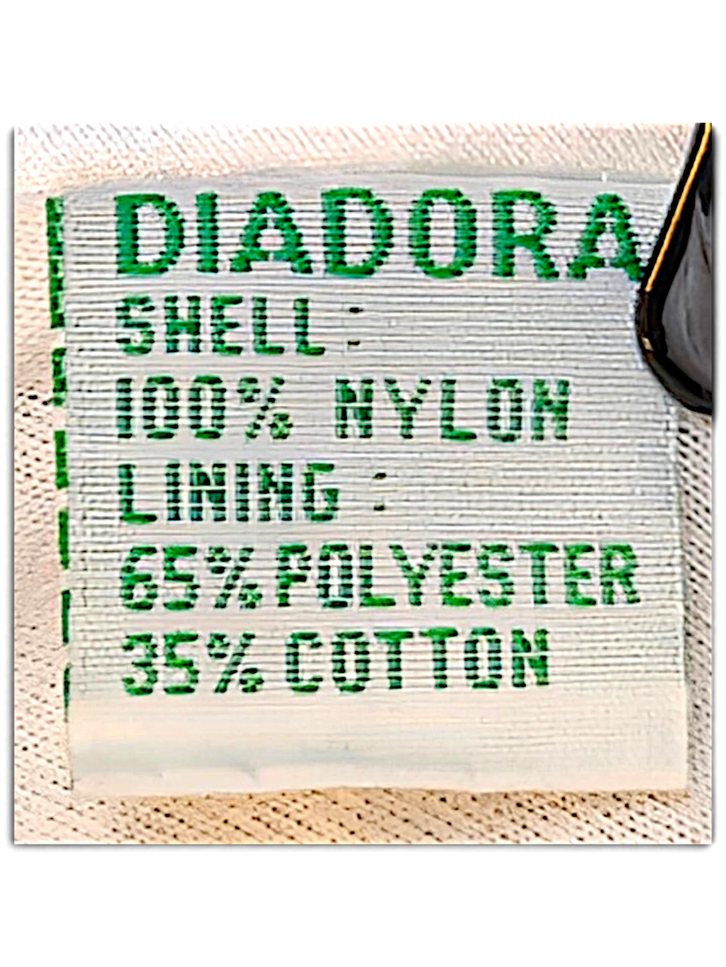 JAKE & IPI Diadora track pants care label showing 100% nylon shell and polyester cotton lining composition