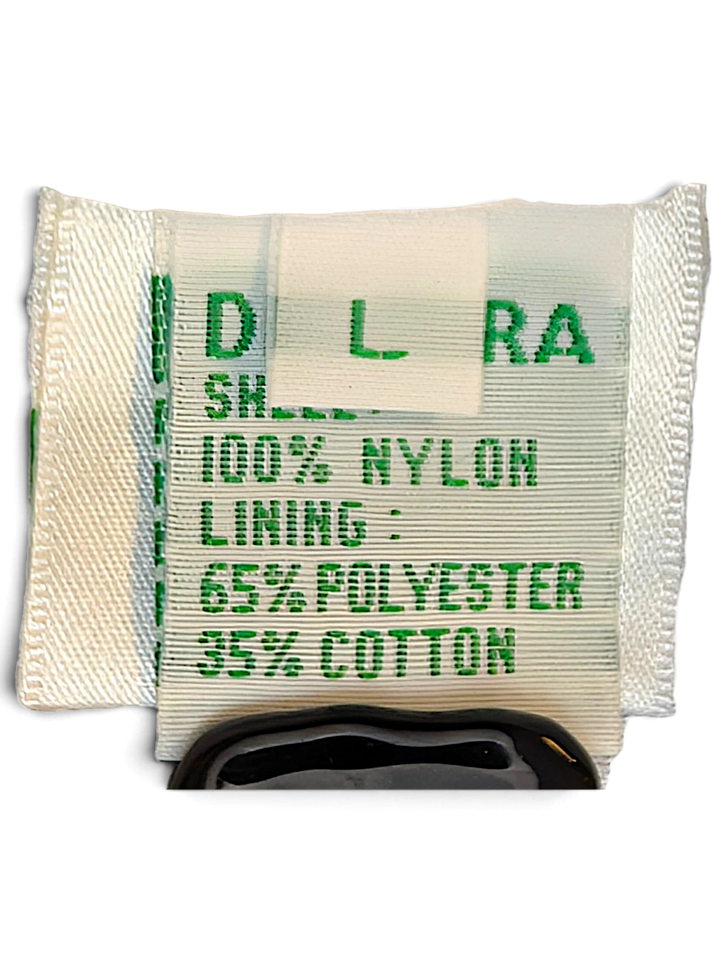 JAKE & IPI Diadora track pants care label showing 100% nylon shell and polyester cotton lining composition