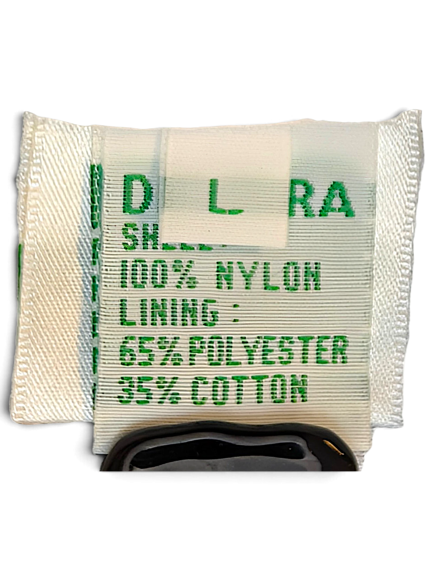 JAKE & IPI Diadora track pants care label showing 100% nylon shell and polyester cotton lining composition