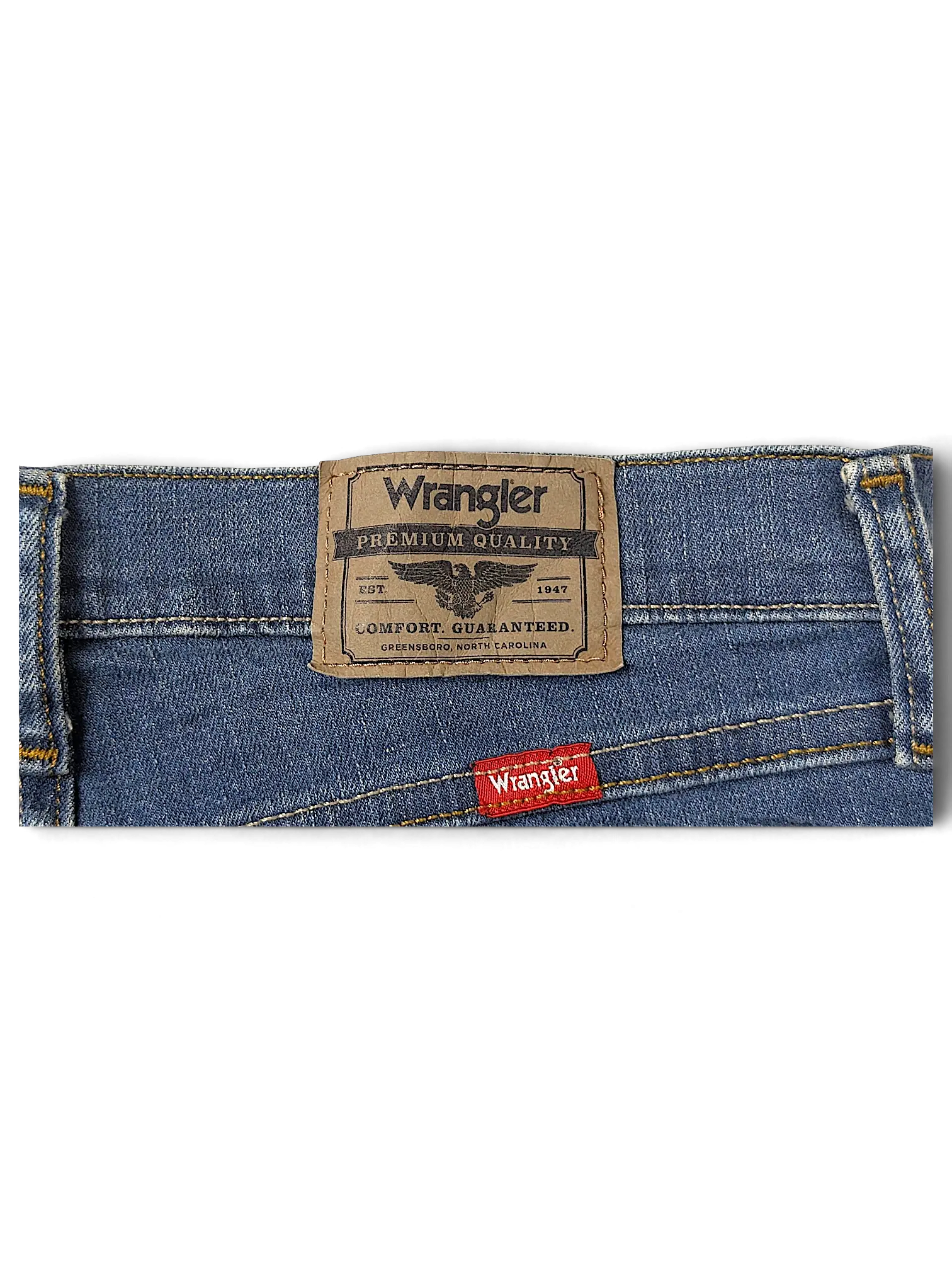 JAKE & IPI Wrangler straight fit blue denim jeans featuring a branded leather back patch and red logo tab.