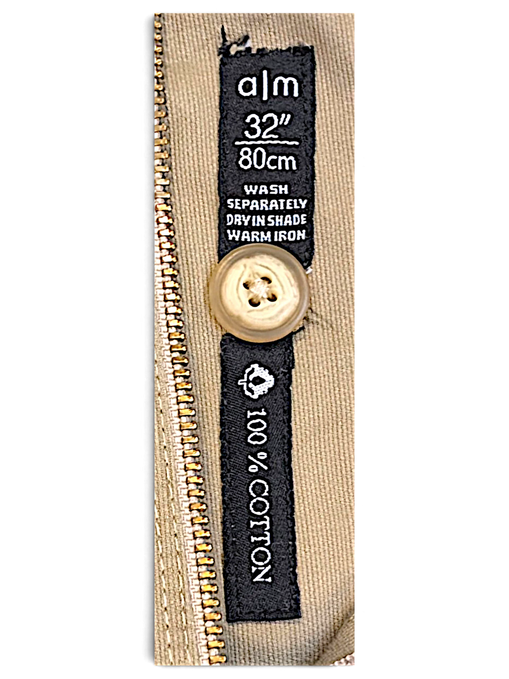 JAKE & IPI A M A La Mode beige cotton trousers label showing size 32 inch 80cm and care instructions