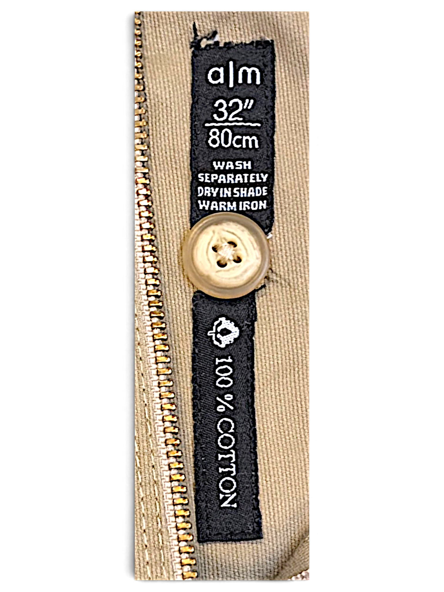 JAKE & IPI A M A La Mode beige cotton trousers label showing size 32 inch 80cm and care instructions