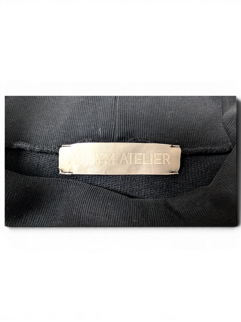 JAKE & IPI black Abnym atelier sweatshirt featuring a branded fabric neck label