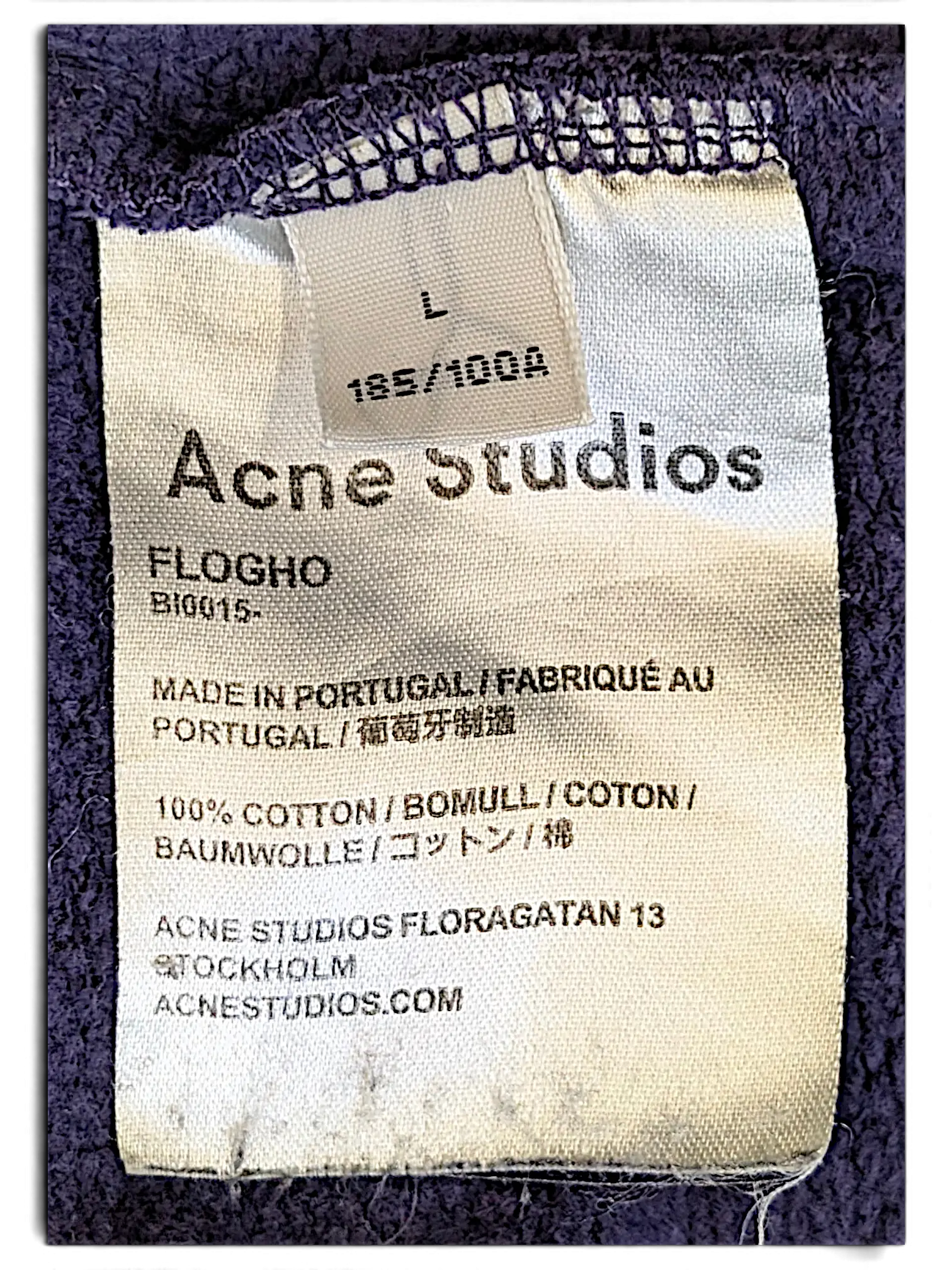 JAKE & IPI Acne Studios purple sweatshirt interior care label showing size L, 100% cotton, and made in Portugal details.