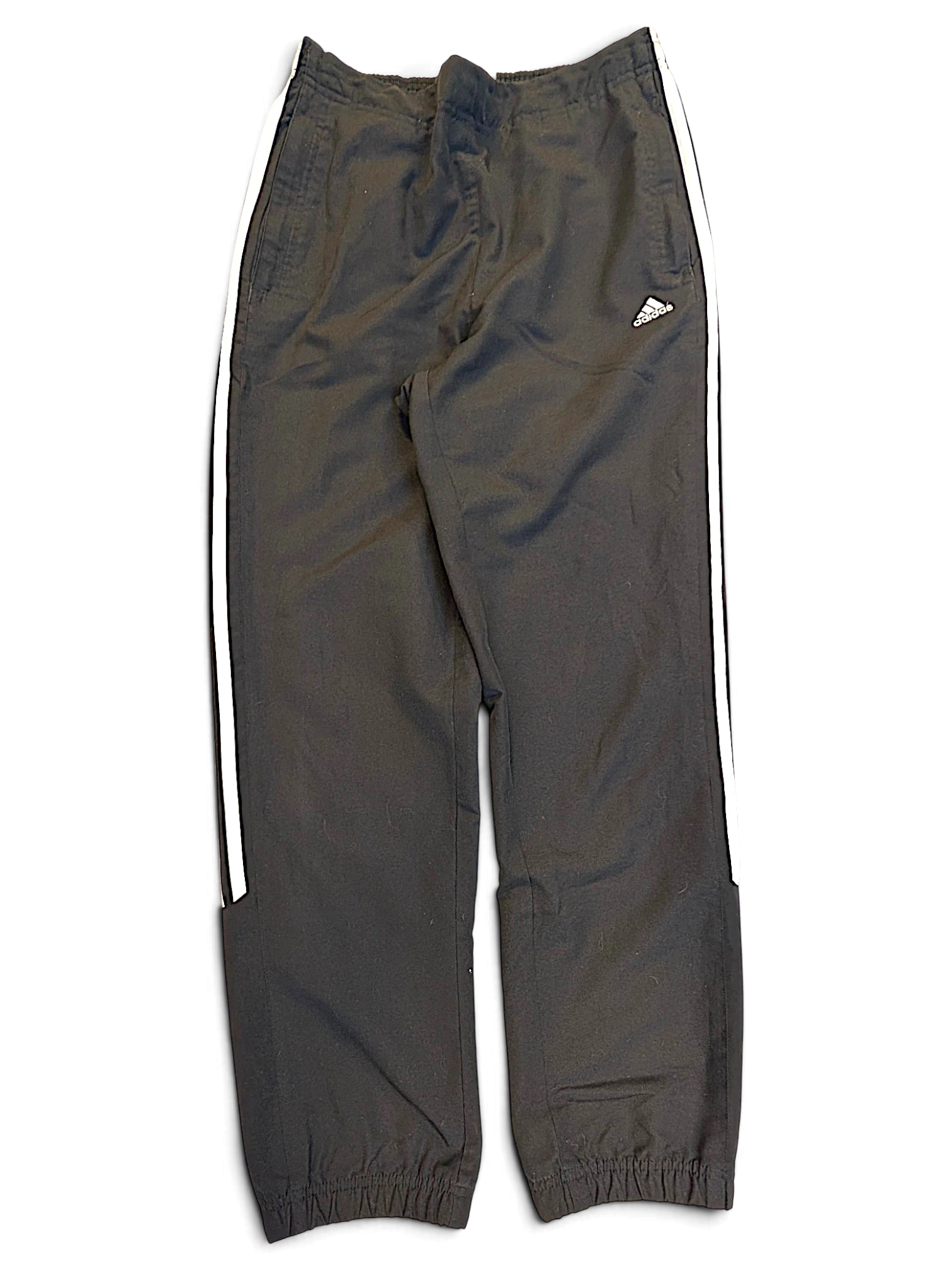 JAKE & IPI pre-owned black adidas track pants with signature white 3-stripes and a tapered leg silhouette.