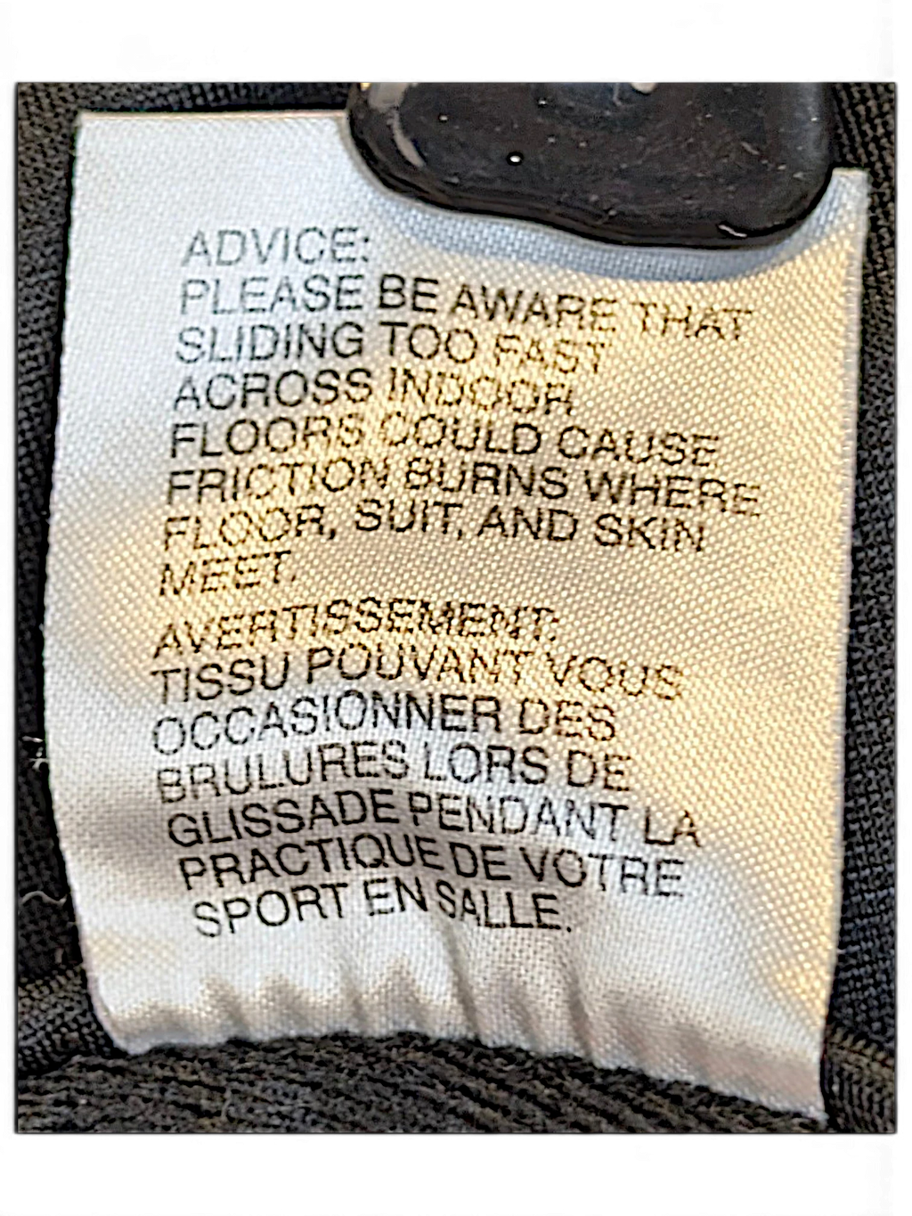 JAKE & IPI adidas track pants care label with safety warning text in English and French