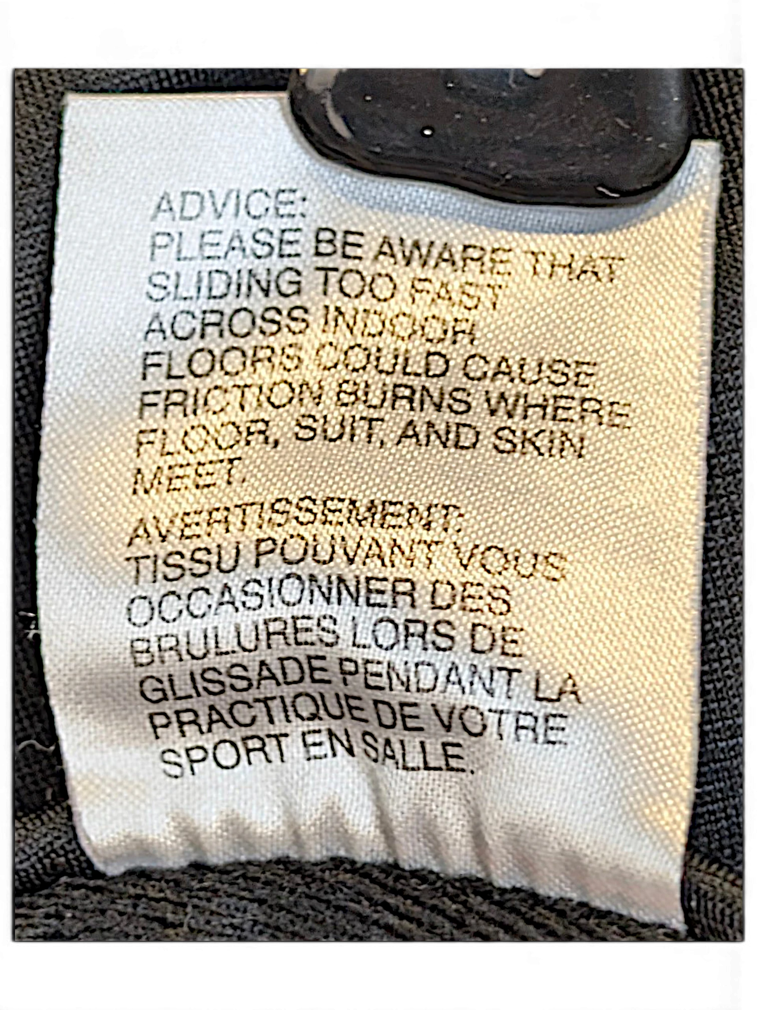 JAKE & IPI adidas track pants care label with safety warning text in English and French