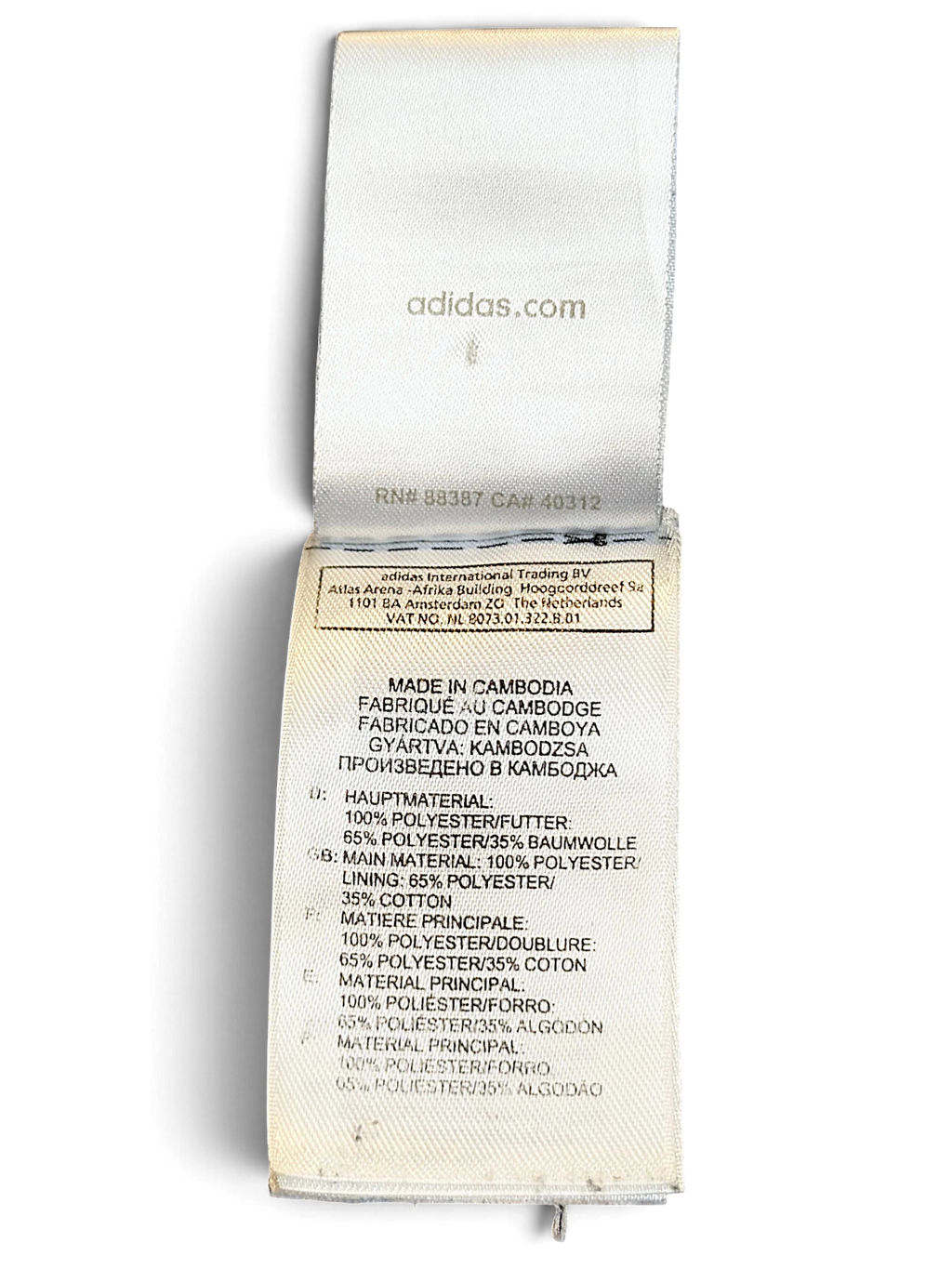 JAKE & IPI adidas track pants care and material label showing polyester and cotton composition