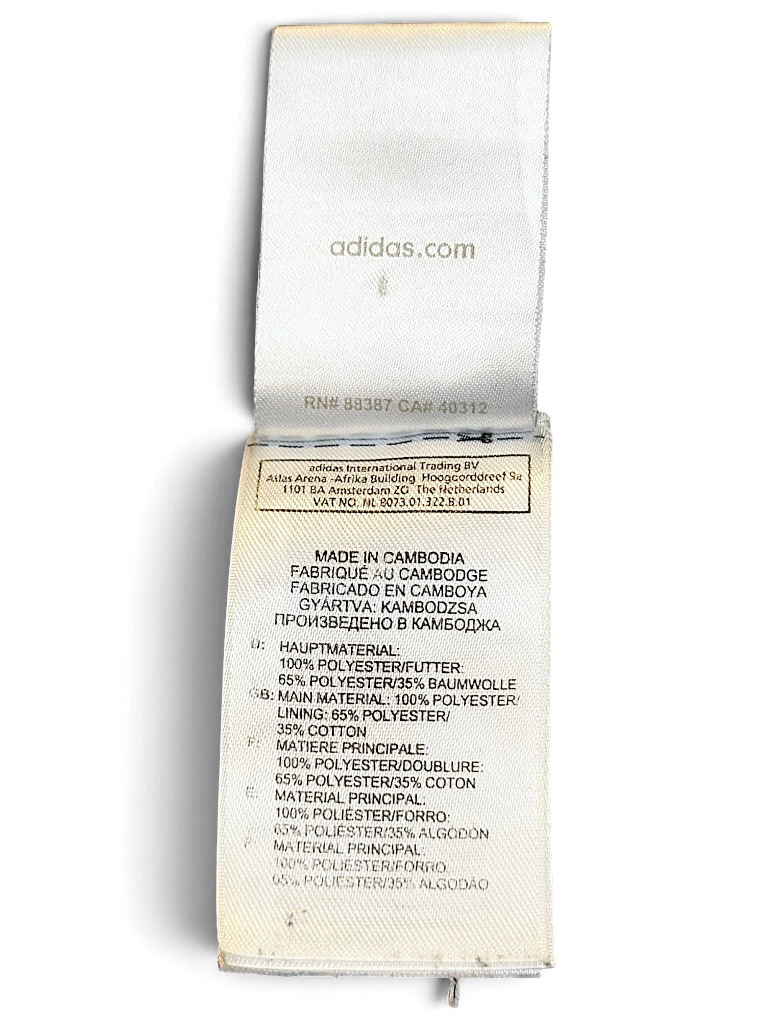 JAKE & IPI adidas track pants care and material label showing polyester and cotton composition