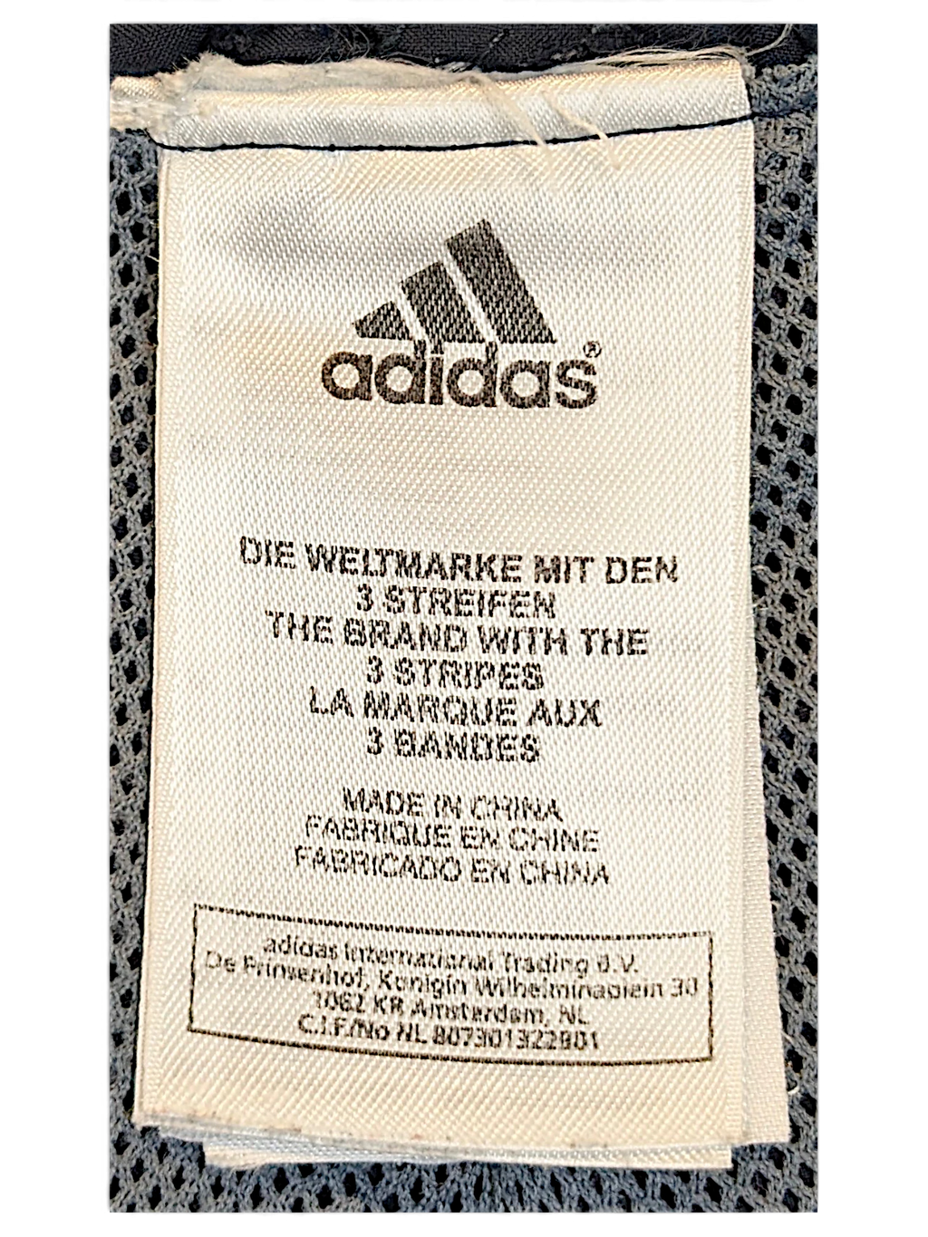 JAKE & IPI adidas track pants white fabric care label with brand logo and manufacturing details