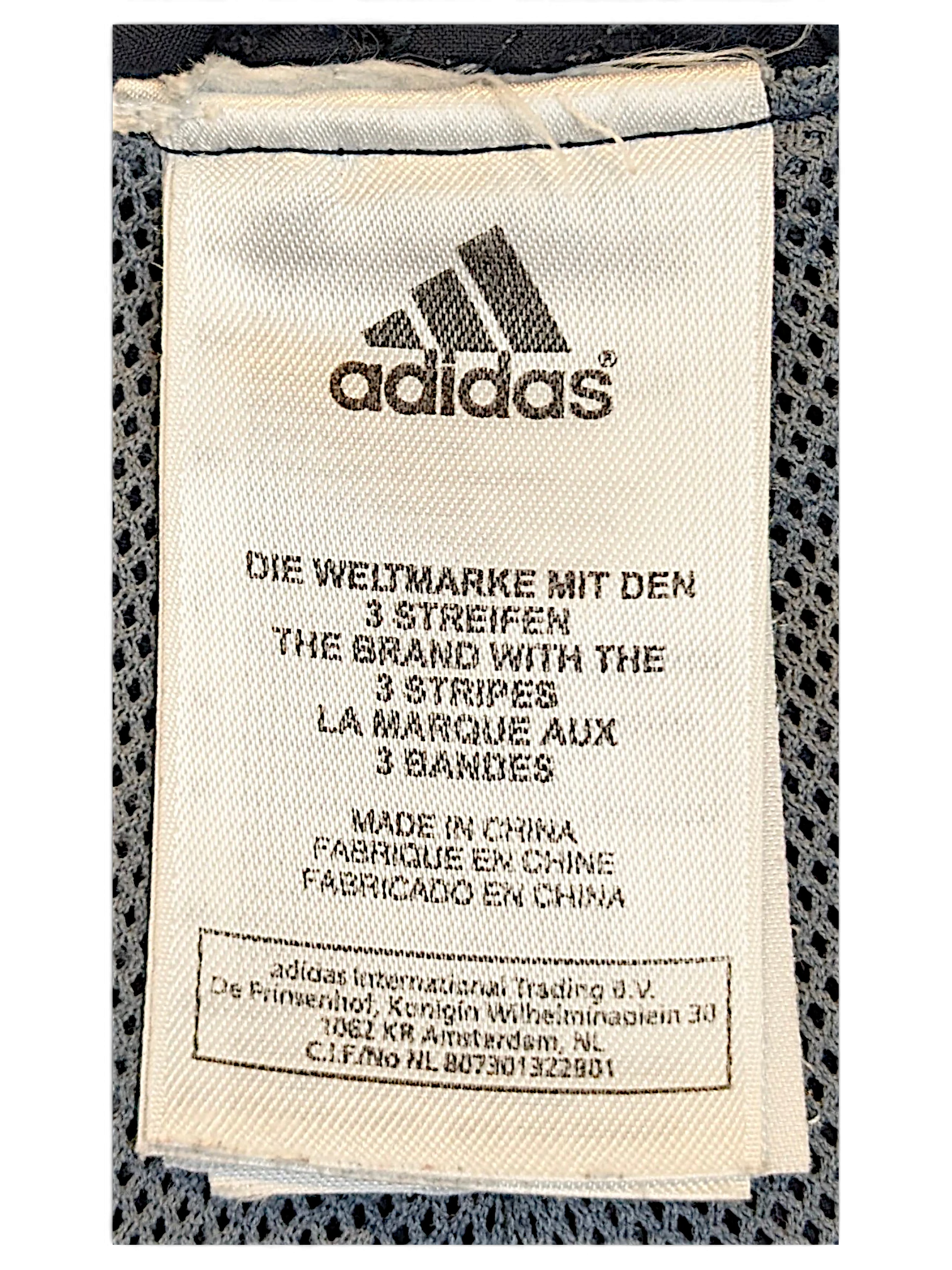 JAKE & IPI adidas track pants white fabric care label with brand logo and manufacturing details
