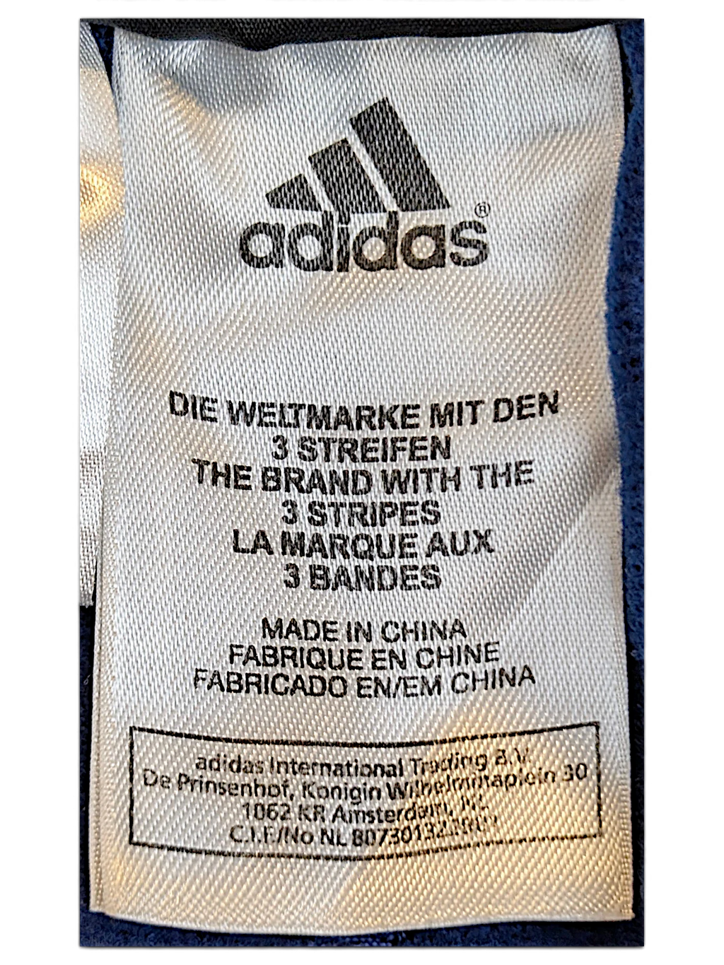 JAKE & IPI adidas track pants white fabric care label with brand logo and manufacturing details