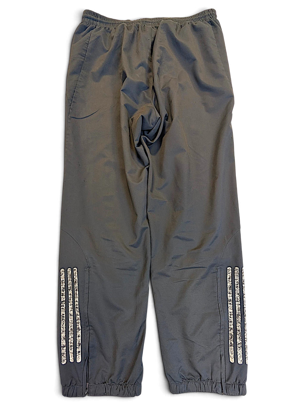 JAKE & IPI pre-owned adidas dark grey track pants with distressed white 3-stripes and zippered leg openings.