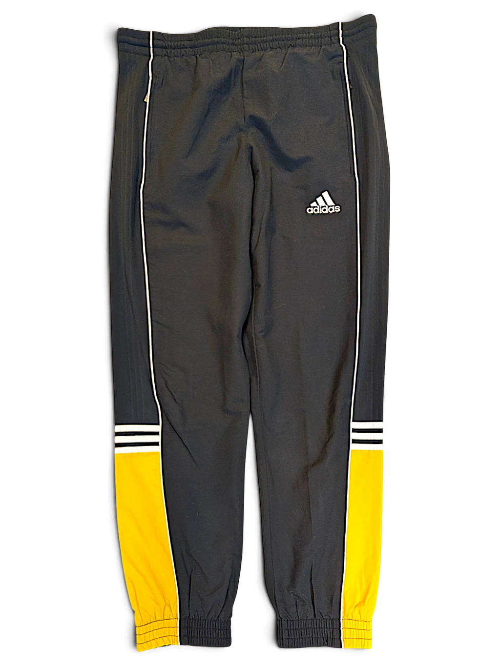 JAKE & IPI pre-owned adidas grey track pants with yellow panels, white piping, and signature branding on the leg.