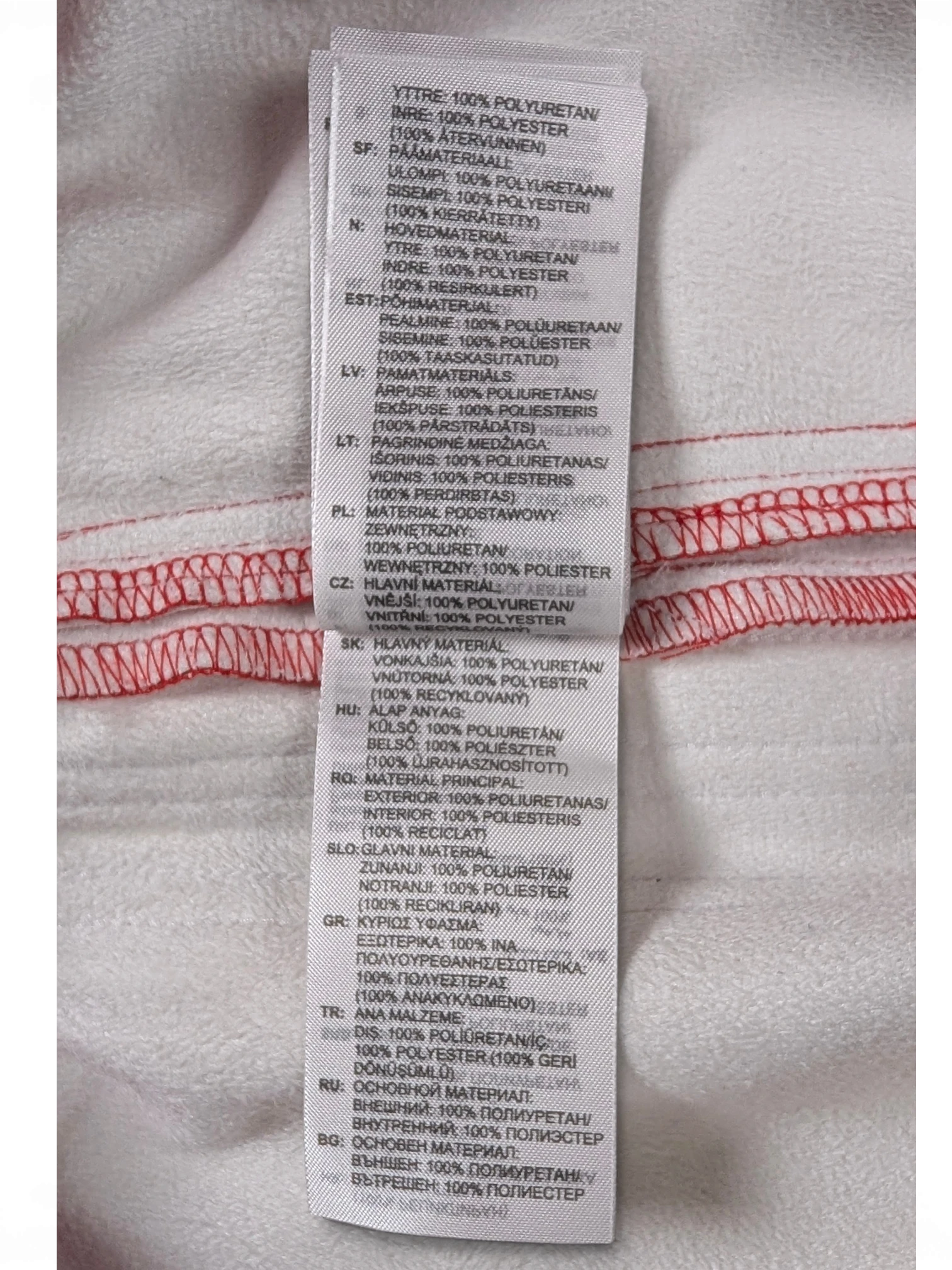 JAKE & IPI Adidas red leather pants care label detailing 100% polyurethane exterior and 100% polyester interior