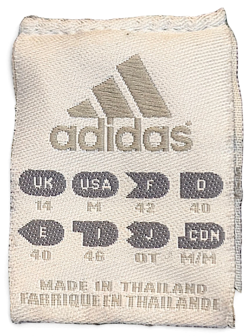 JAKE & IPI adidas track pants size label showing size M and manufacturing details on a white fabric tag