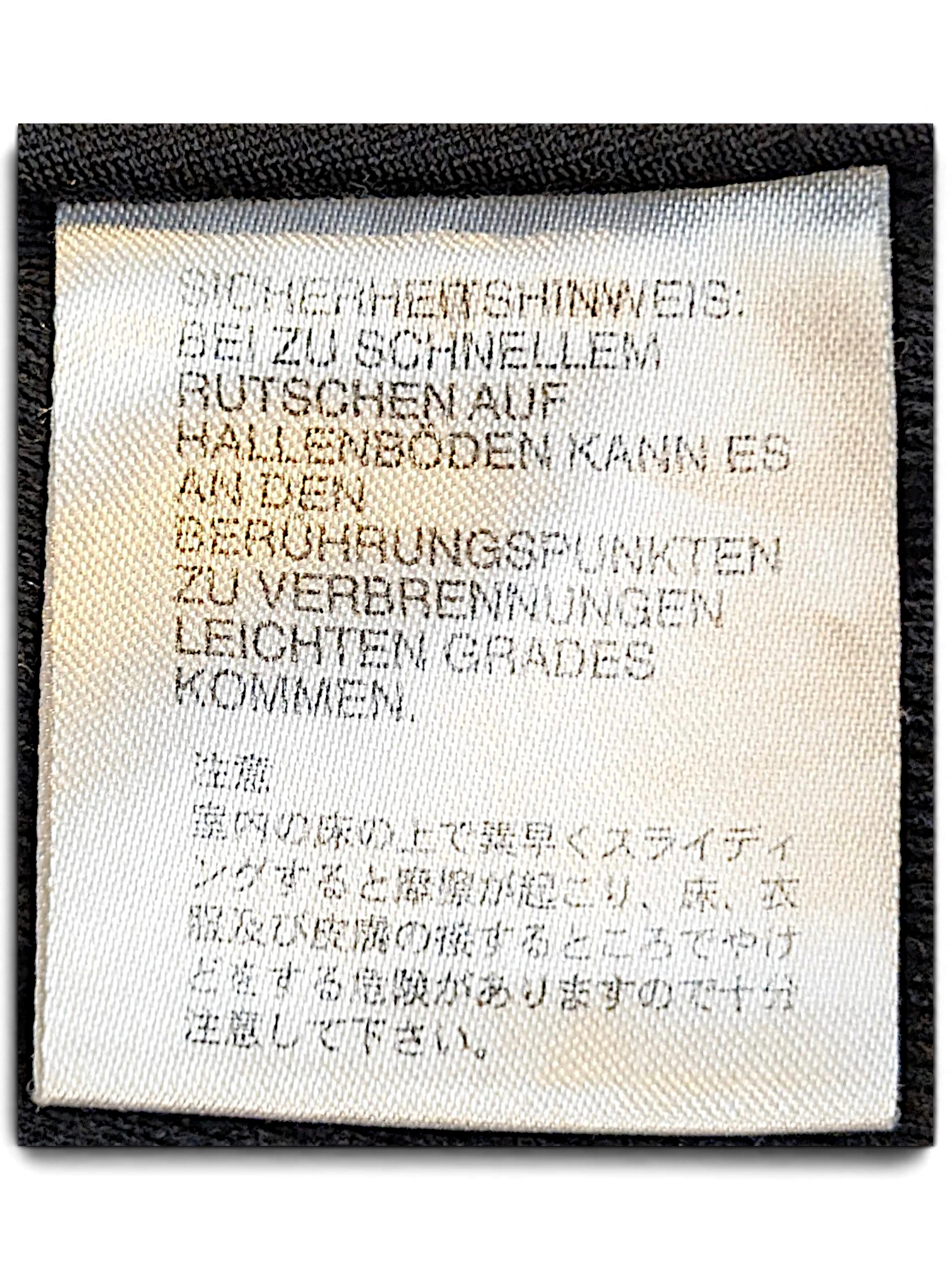 JAKE & IPI adidas track pants care label with safety warning text in German and Japanese