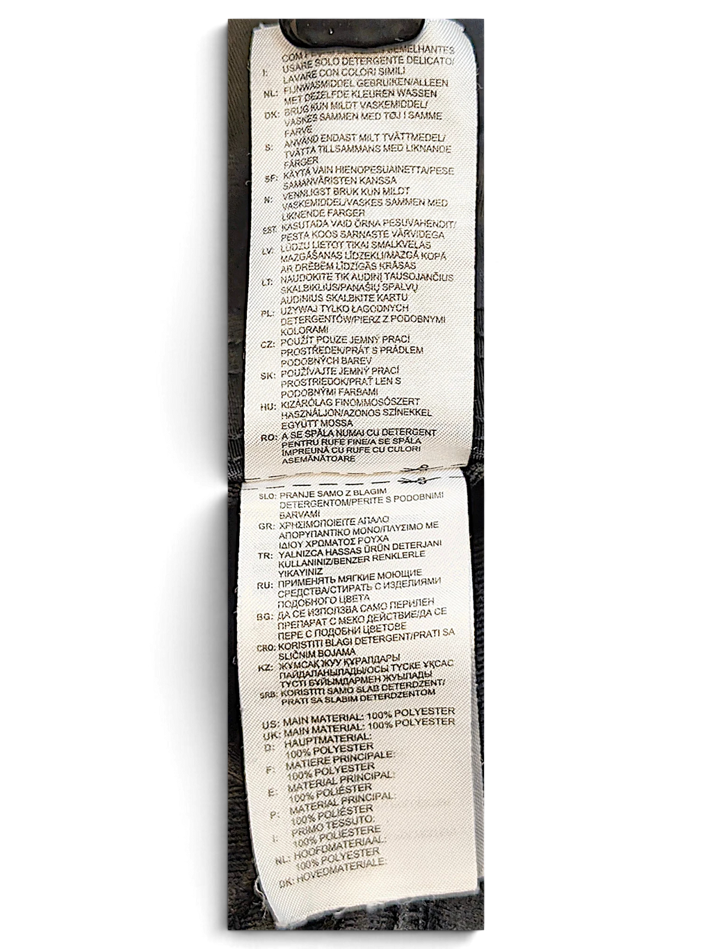 JAKE & IPI adidas track pants care and material label showing 100 percent polyester composition in multiple languages