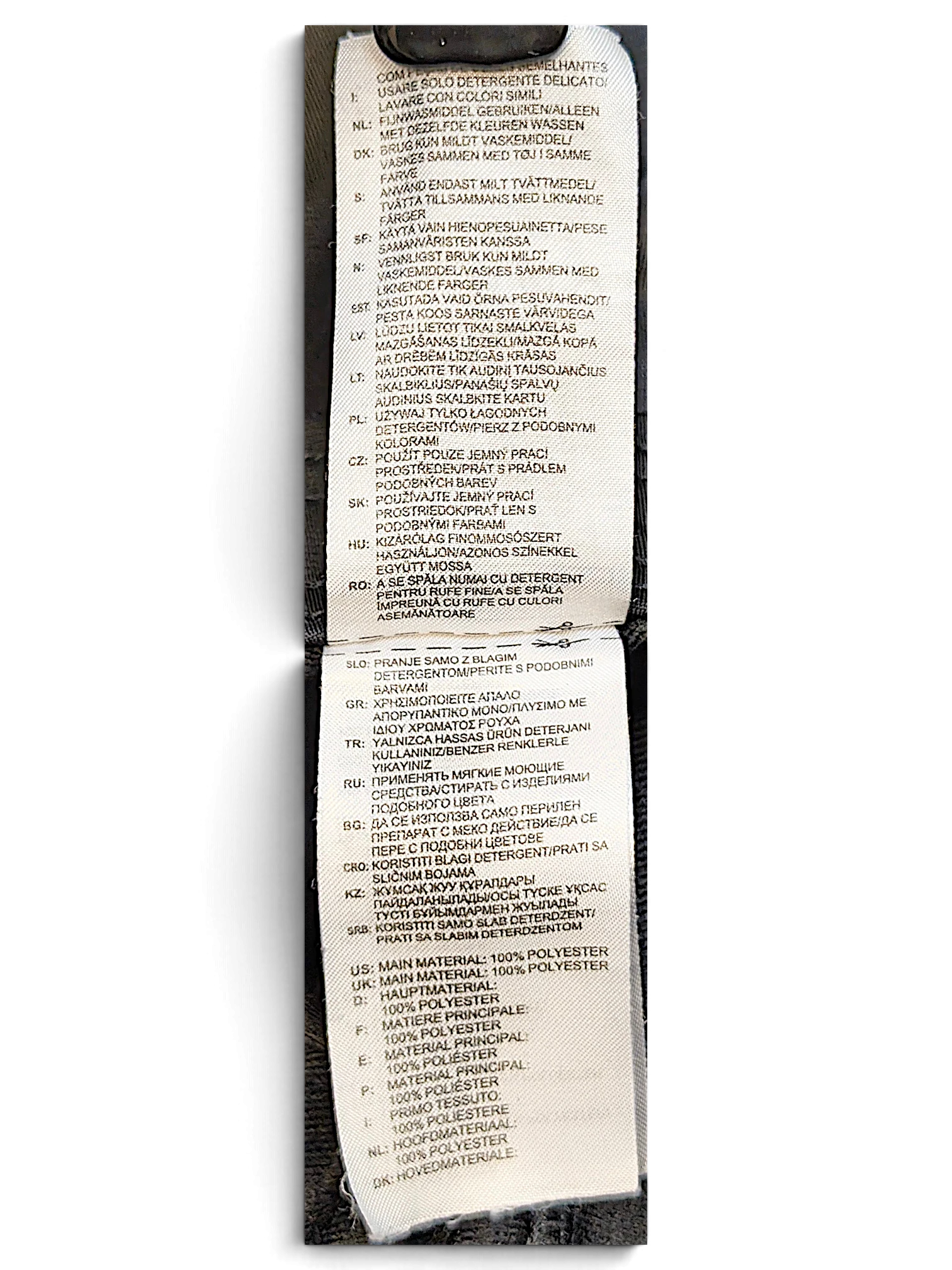 JAKE & IPI adidas track pants care and material label showing 100 percent polyester composition in multiple languages
