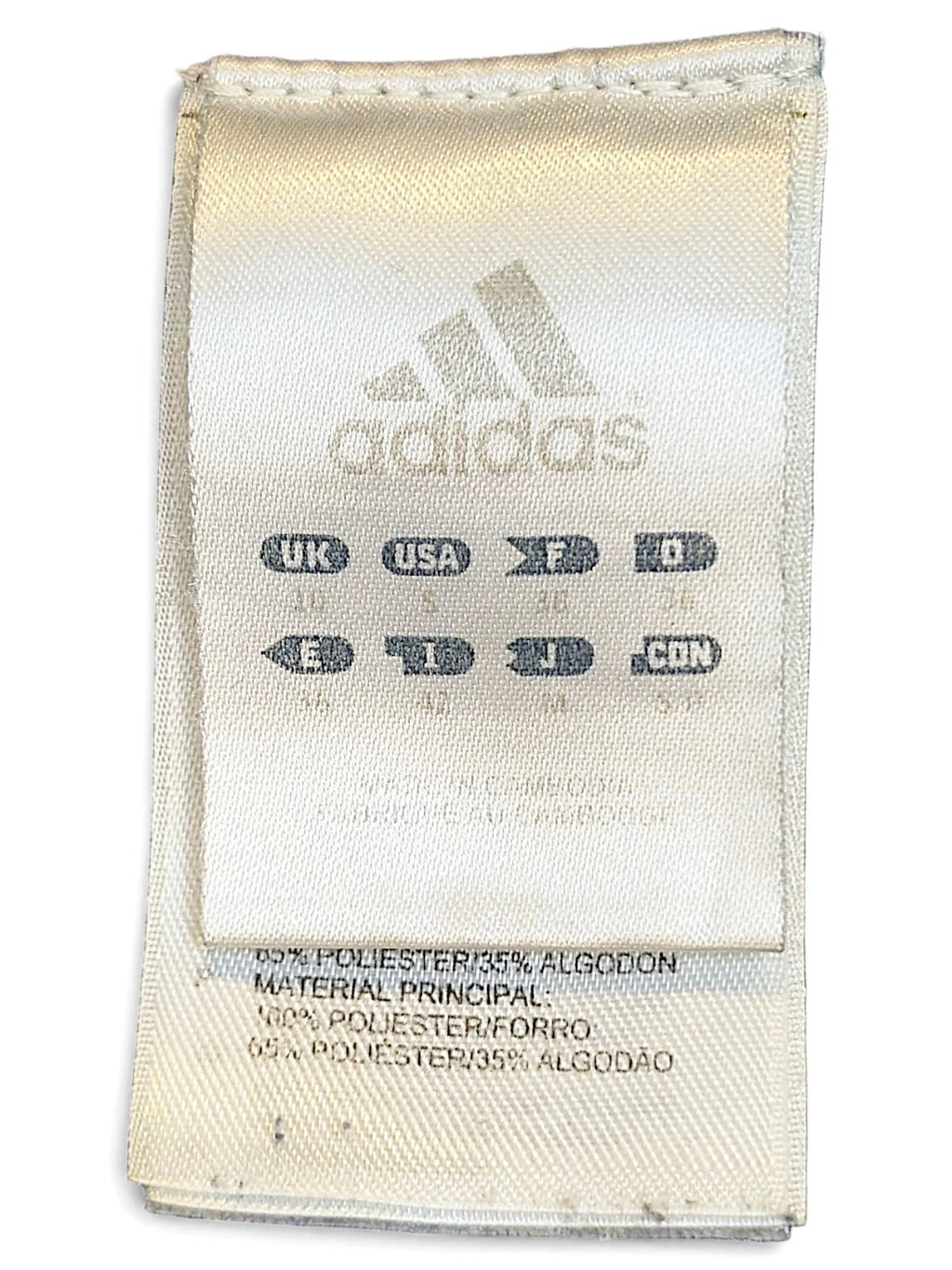 JAKE & IPI adidas track pants internal care and size label showing material composition and international sizing