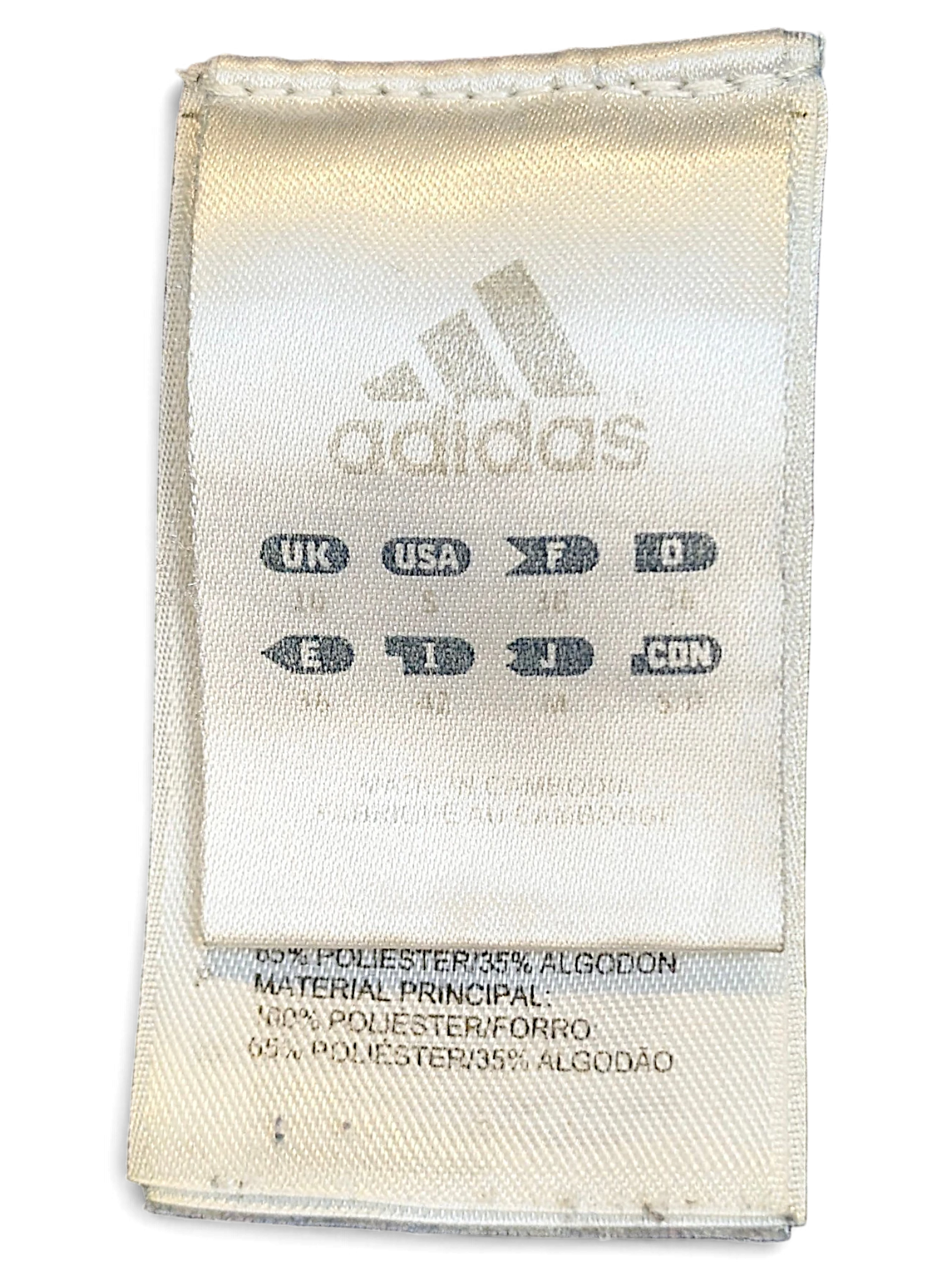 JAKE & IPI adidas track pants internal care and size label showing material composition and international sizing