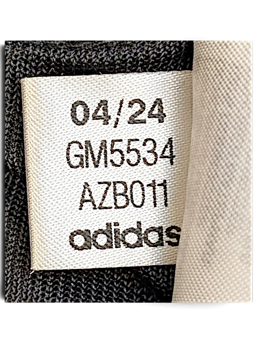 JAKE & IPI adidas track pants internal garment label showing production code GM5534 and date 04/24