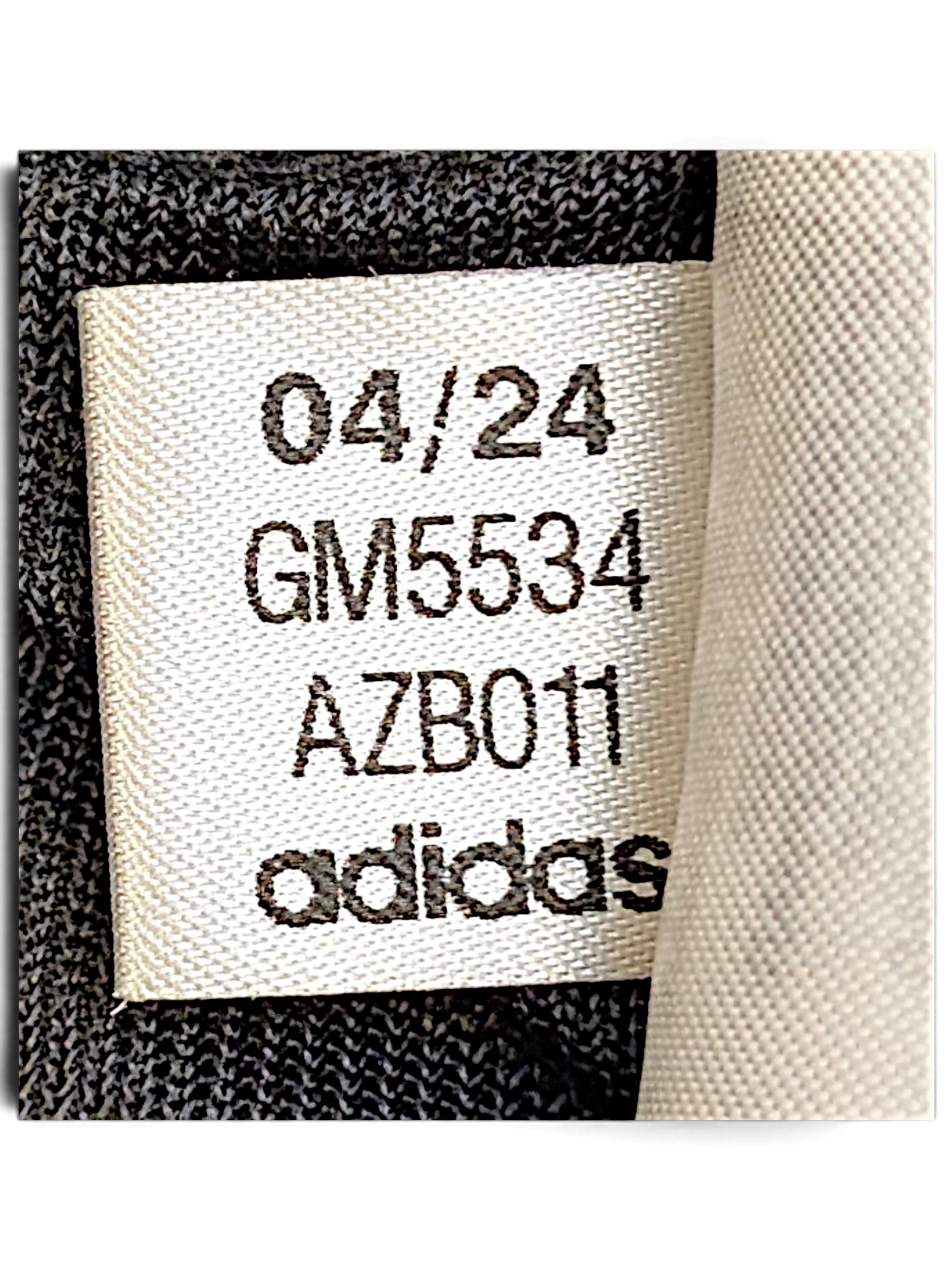 JAKE & IPI adidas track pants internal garment label showing production code GM5534 and date 04/24