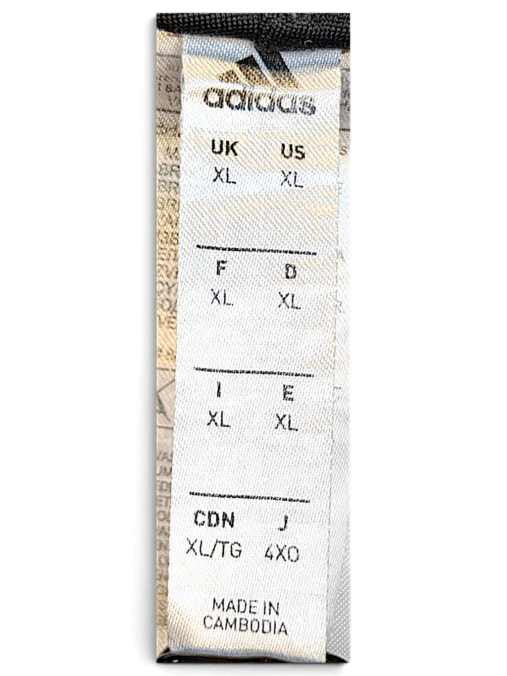 JAKE & IPI adidas track pants size XL label showing international sizing and Cambodia origin