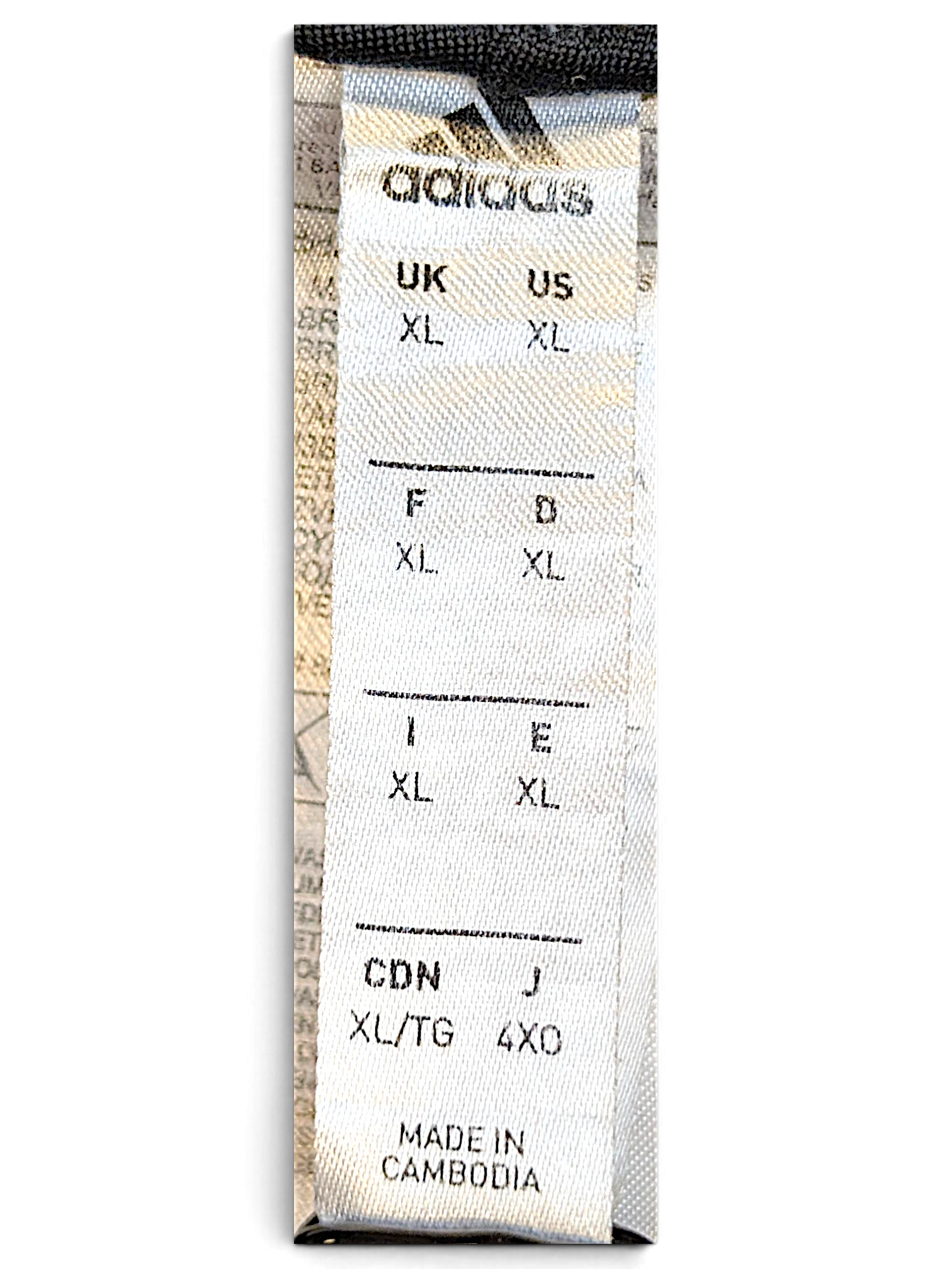 JAKE & IPI adidas track pants size XL label showing international sizing and Cambodia origin