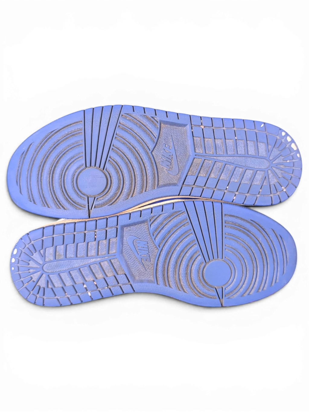 JAKE & IPI Air Jordan 1 Retro High Hyper Royal sneakers showing the blue rubber outsoles with traction patterns