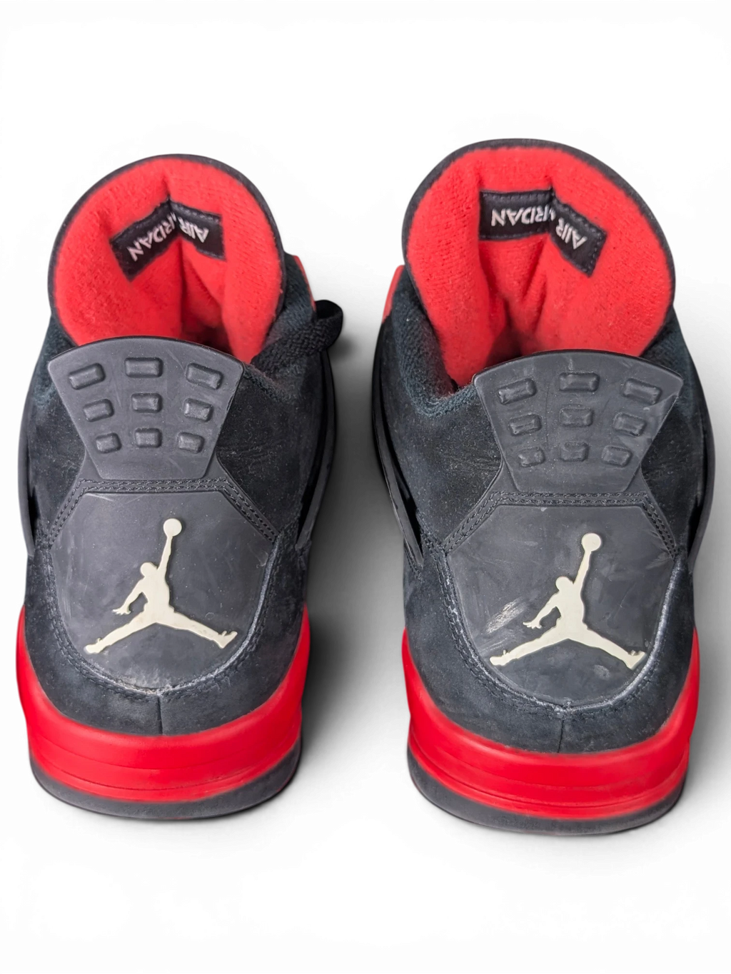 JAKE & IPI Air Jordan 4 Red Thunder sneakers in black and red with visible wear on the heel tabs