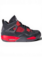 JAKE & IPI pre-owned black and red Air Jordan 4 Red Thunder sneakers with visible wear on a black background.