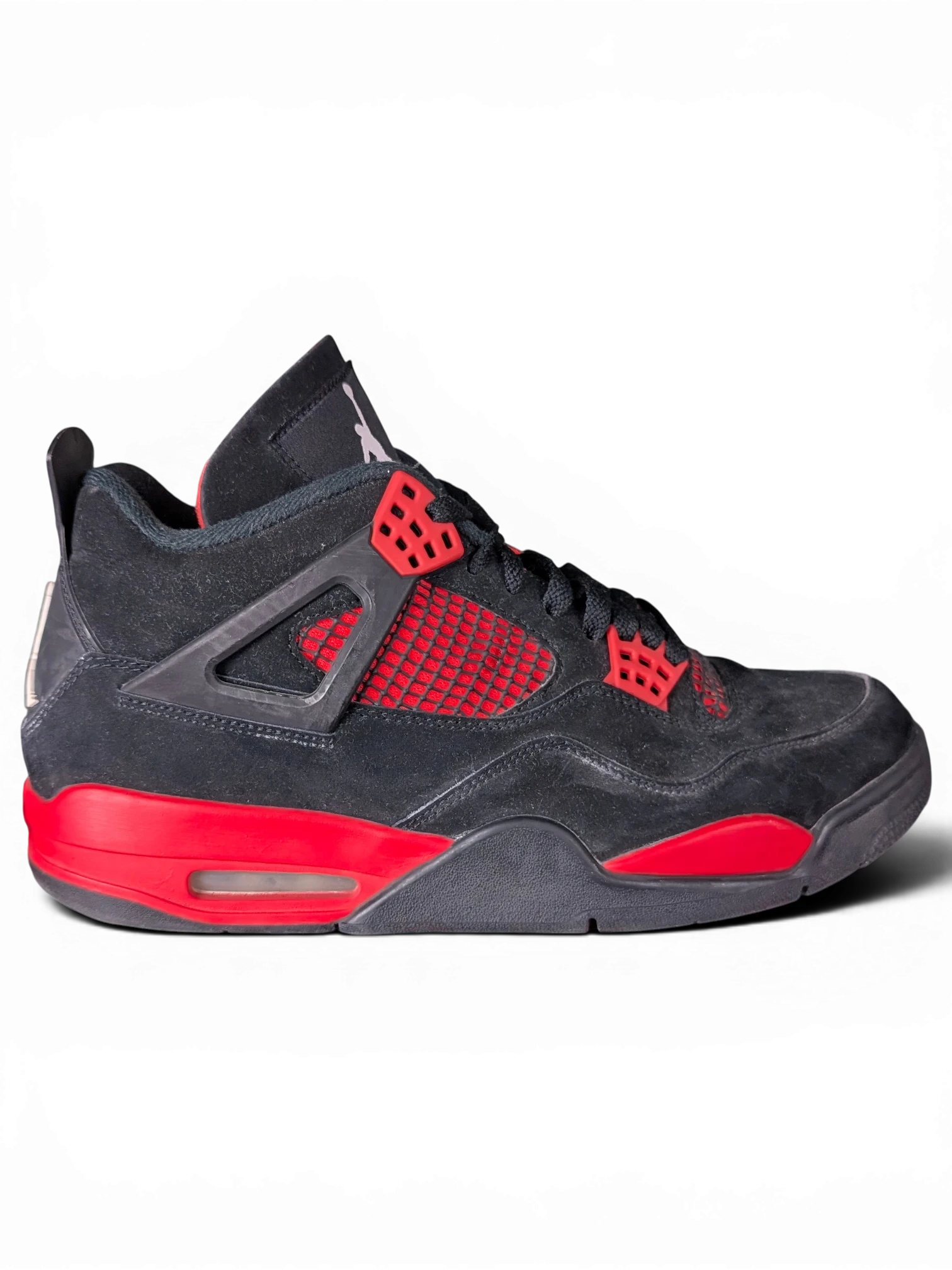 JAKE & IPI pre-owned black and red Air Jordan 4 Red Thunder sneakers with visible wear on a black background.