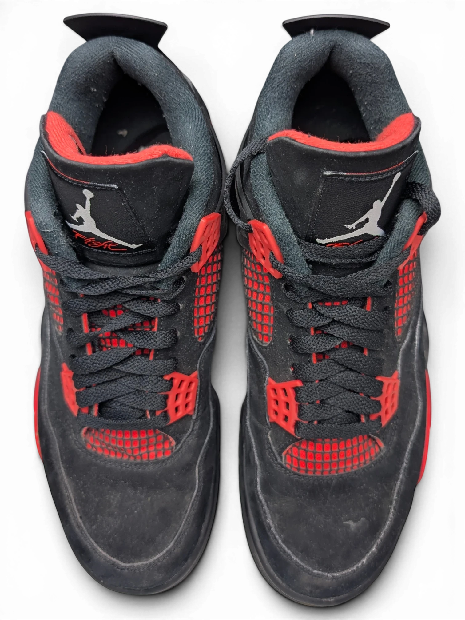 JAKE & IPI pre-owned Air Jordan 4 Red Thunder sneakers in black and red with visible wear on the nubuck upper.