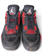 JAKE & IPI Air Jordan 4 Red Thunder sneakers in black nubuck with vibrant red accents and Jumpman tongue branding.