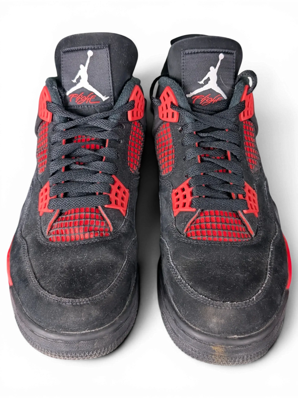 JAKE & IPI Air Jordan 4 Red Thunder sneakers in black nubuck with vibrant red accents and Jumpman tongue branding.