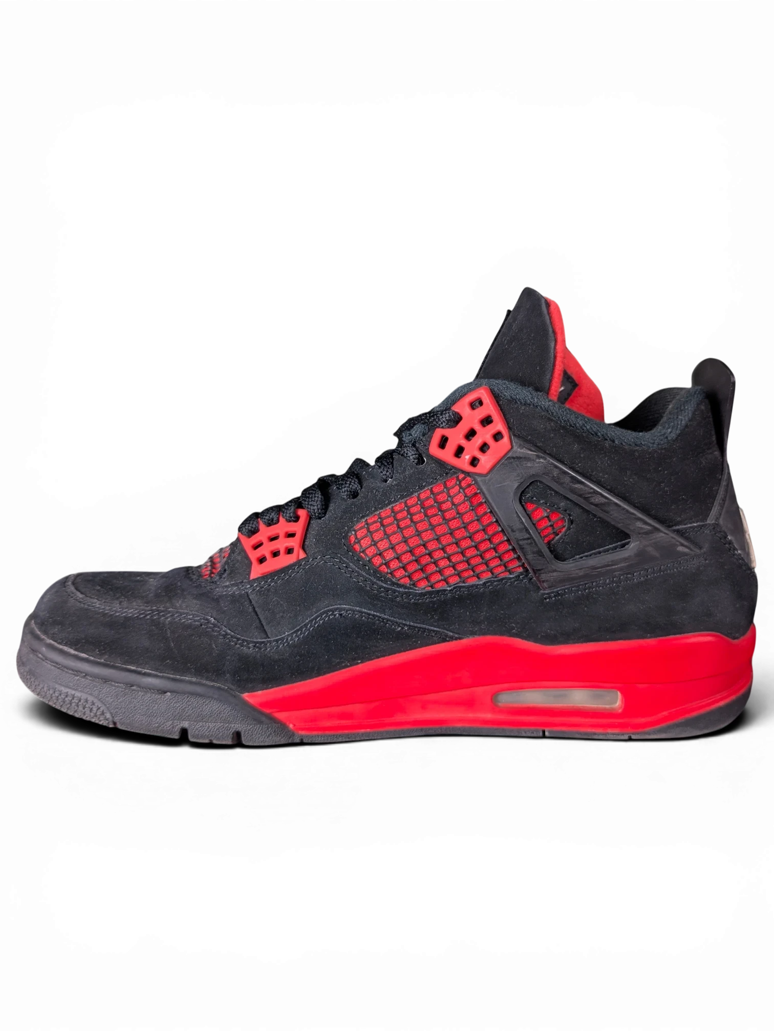 JAKE & IPI Air Jordan 4 Red Thunder sneakers in black suede with red accents and visible wear on a black background.