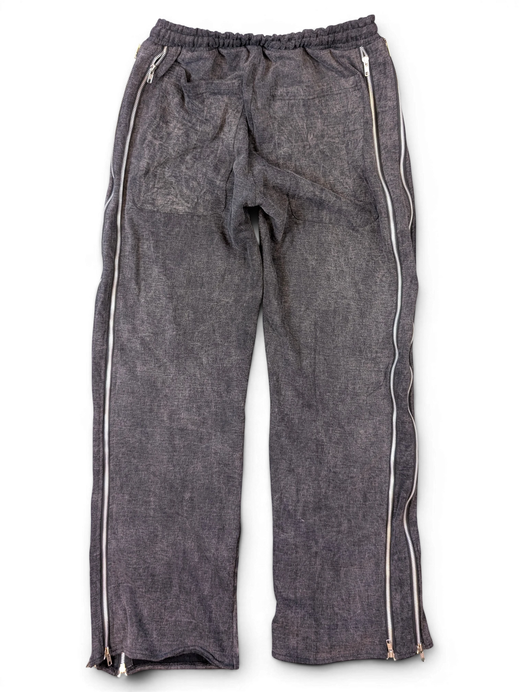 JAKE & IPI Alarikco track suit pants in charcoal grey with full-length side zippers on a black background