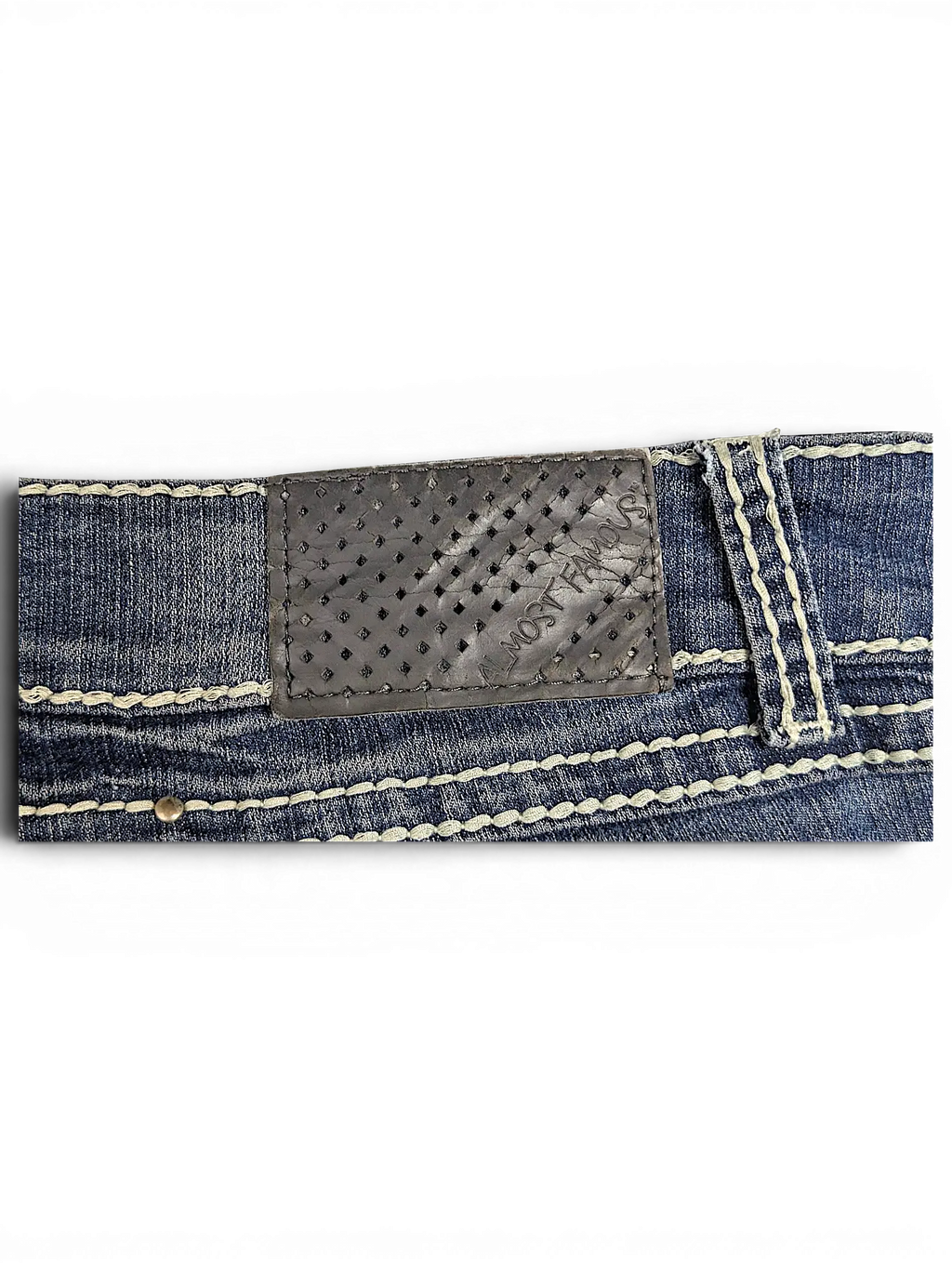 JAKE & IPI Almost Famous distressed blue denim jeans featuring a perforated leather back patch and thick stitching.