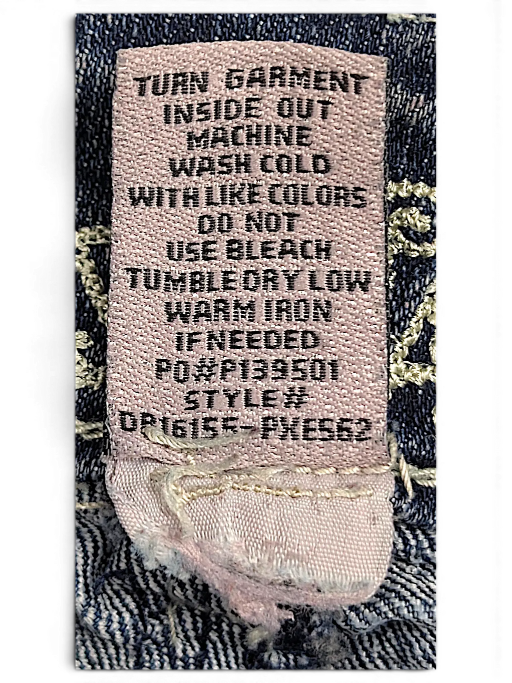 JAKE & IPI Almost Famous distressed jeans care label with washing instructions and style number details