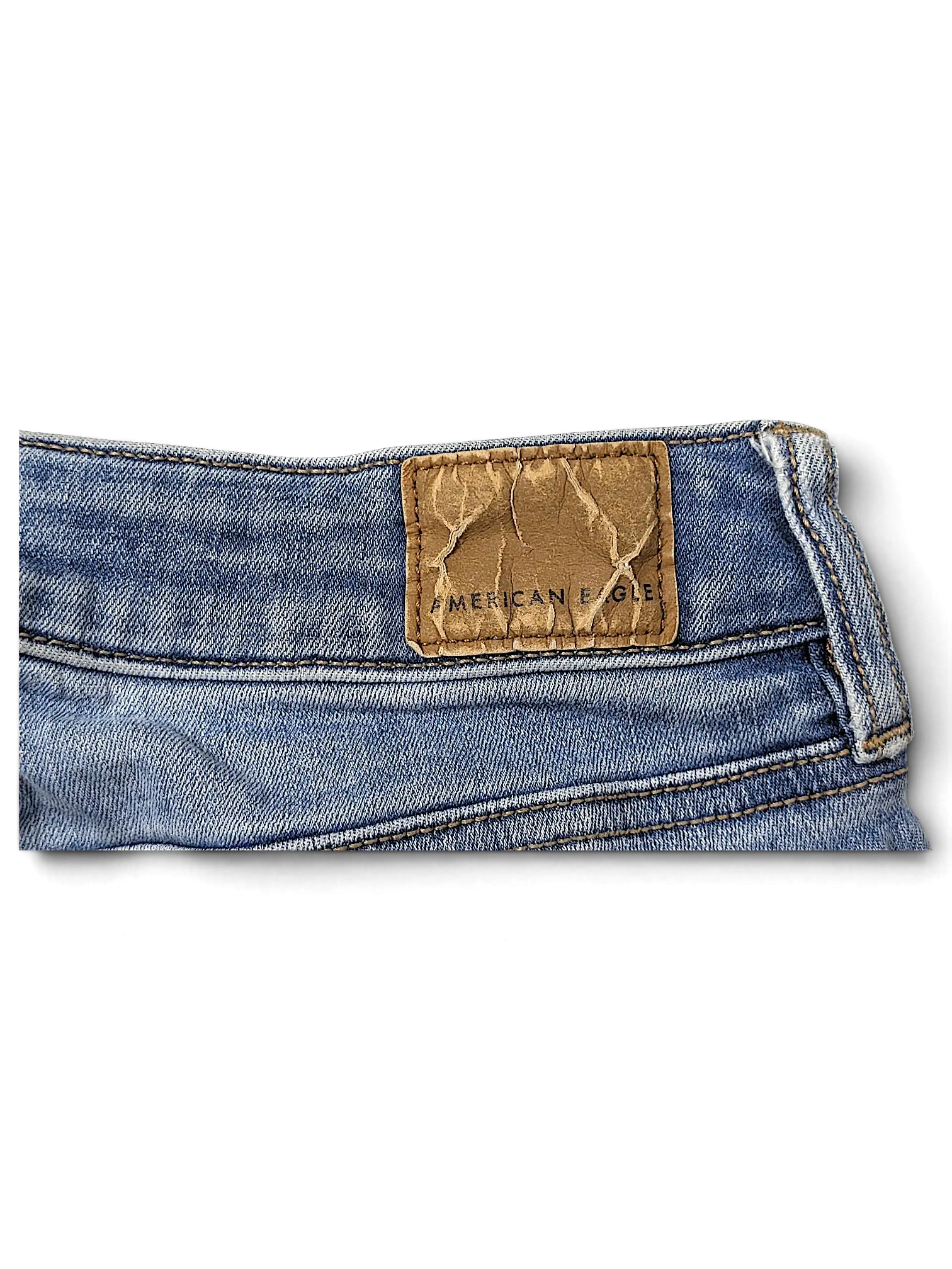 JAKE & IPI American Eagle Outfitters blue denim jeans featuring a textured brown leather brand patch on the waistband