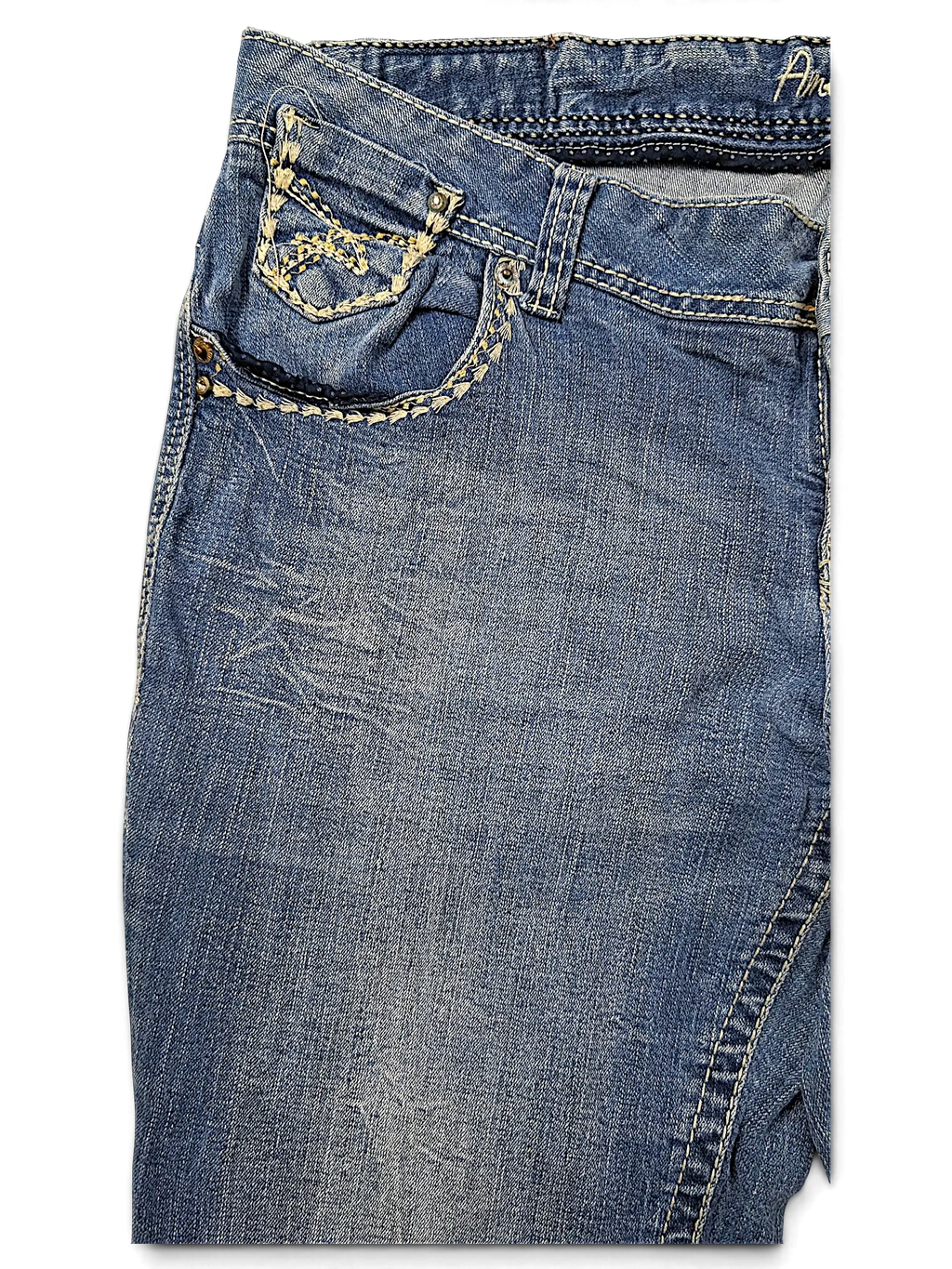 JAKE & IPI Amethyst Y2K blue denim jeans featuring decorative cream stitching and metal stud details on the pocket.