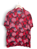 JAKE & IPI Angelo Litrico red Hawaiian shirt with a tropical floral print and short sleeves on a wooden hanger