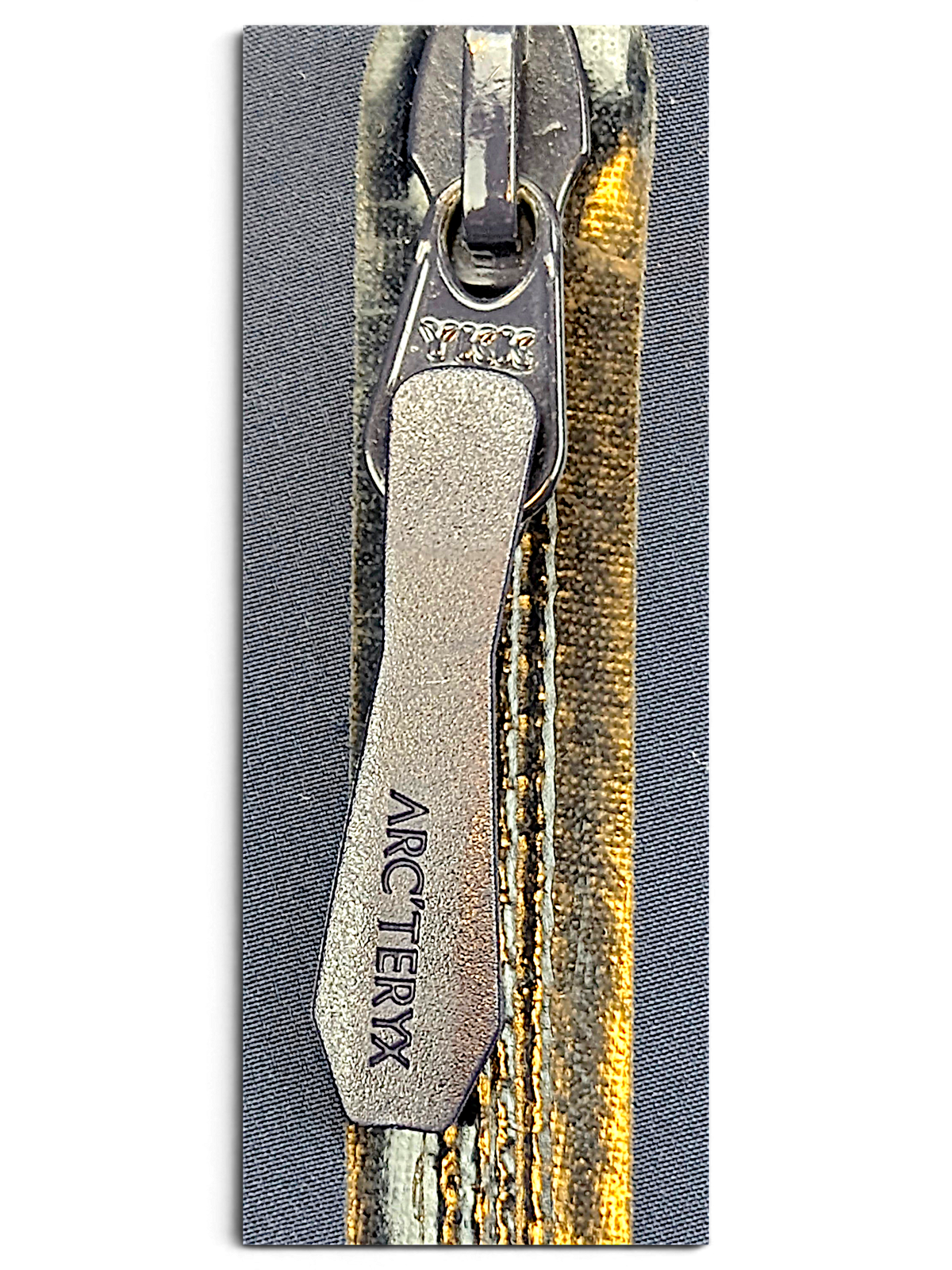Arc'teryx jacket zip detail showing visible wear and discolouration