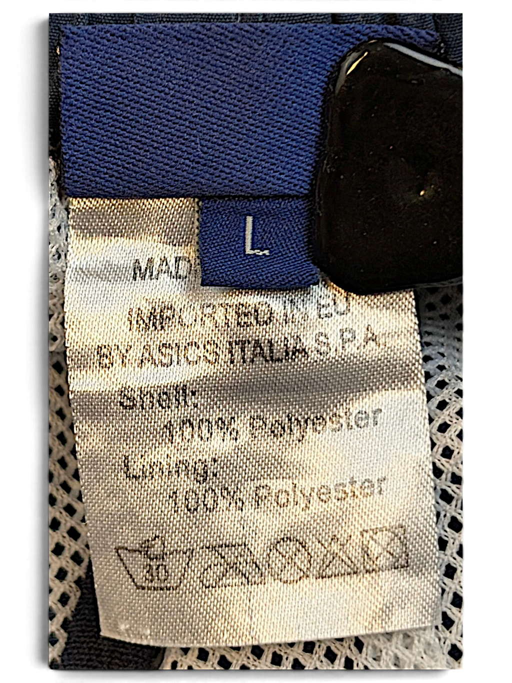 JAKE & IPI ASICS track pants size L label showing 100 percent polyester composition and care instructions